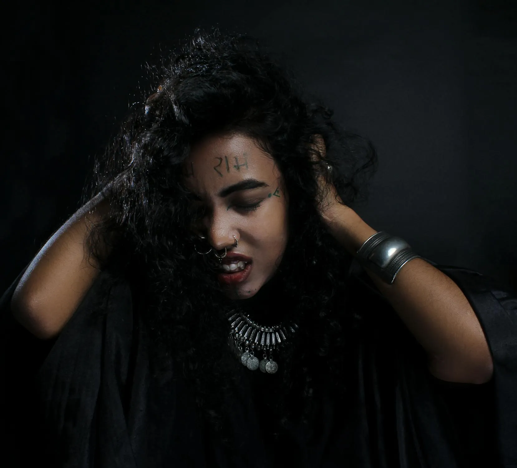 Woman with Wild Hair and Dark Makeup Making a Fierce Face