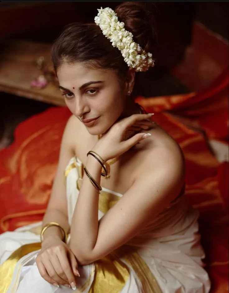 Woman with a jasmine flower on her head sitting on the floor