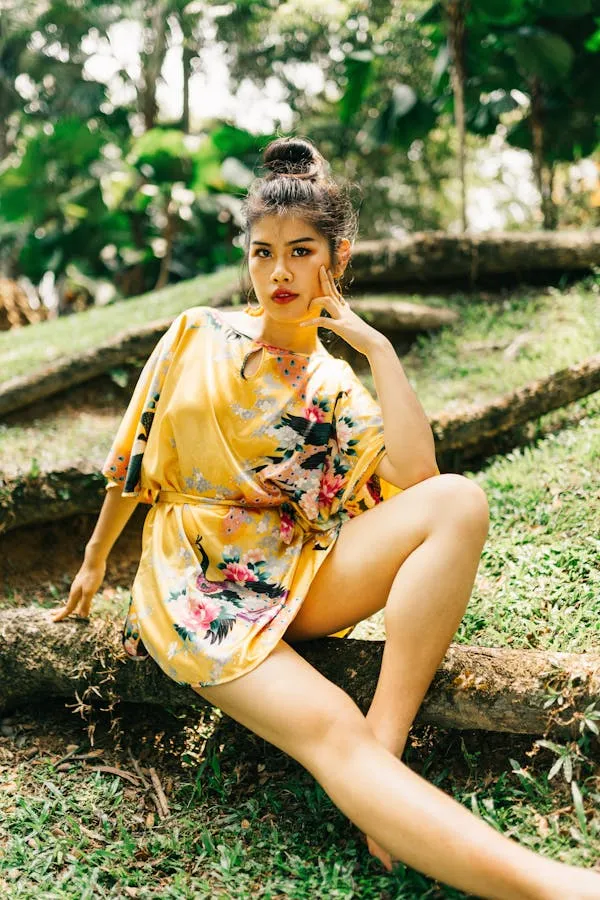 Woman in a Yellow Floral Dress Is Relaxing in a Park Image