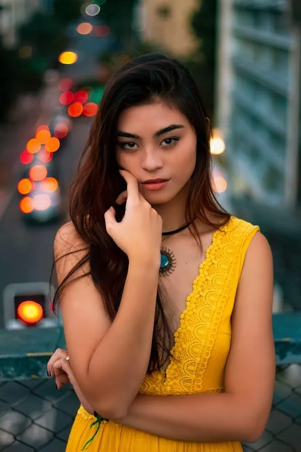 Women in a Yellow Dress Standing in Front of City Lights