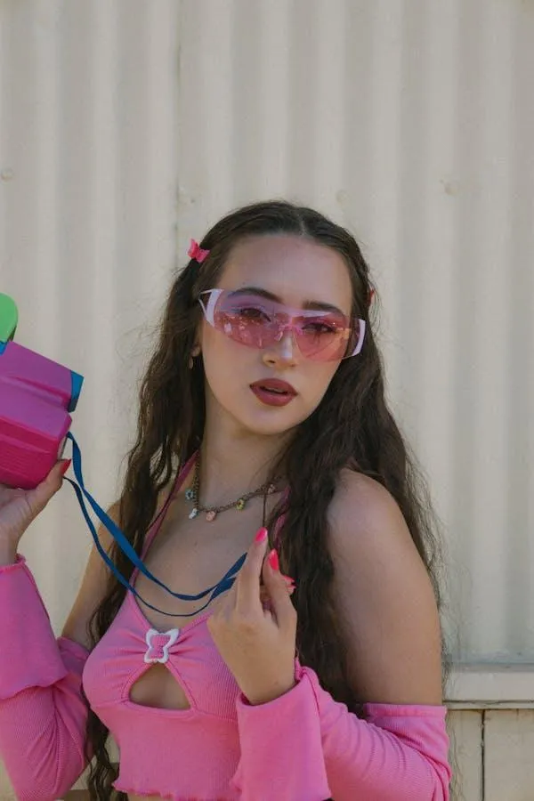 Young Woman with Bold Style Posing in a Trendy Pink Outfit