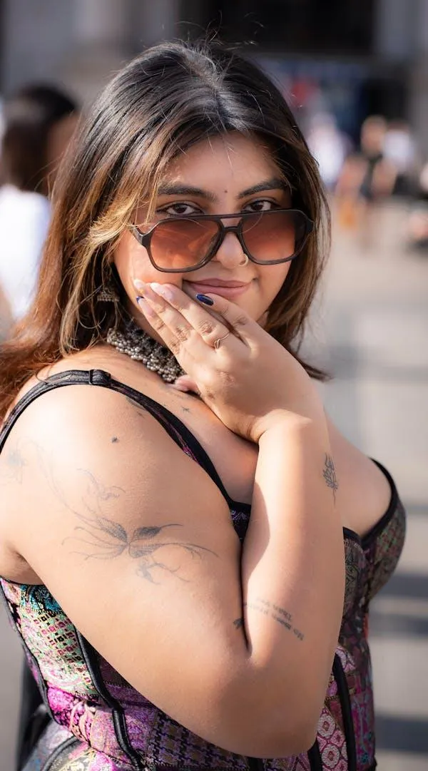 Young Woman in Glasses Thinking with Her Hand Near Her Chin