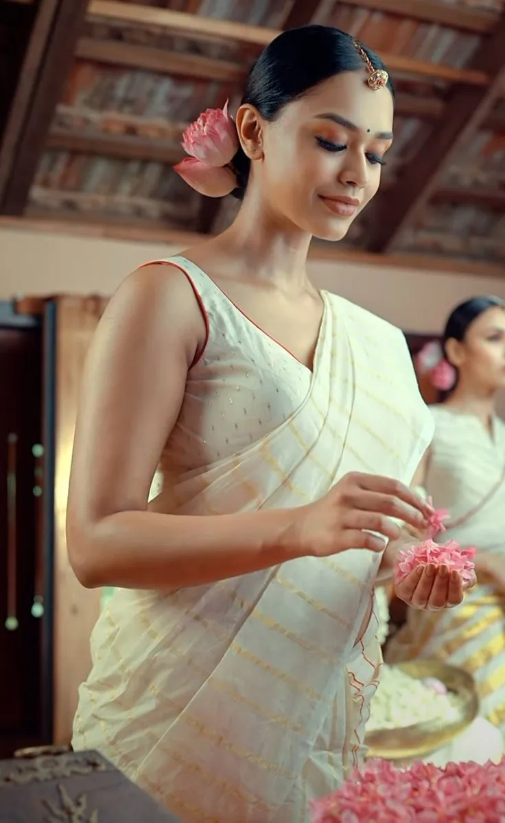 Young woman in a nerial saree with lotus flower on her hair