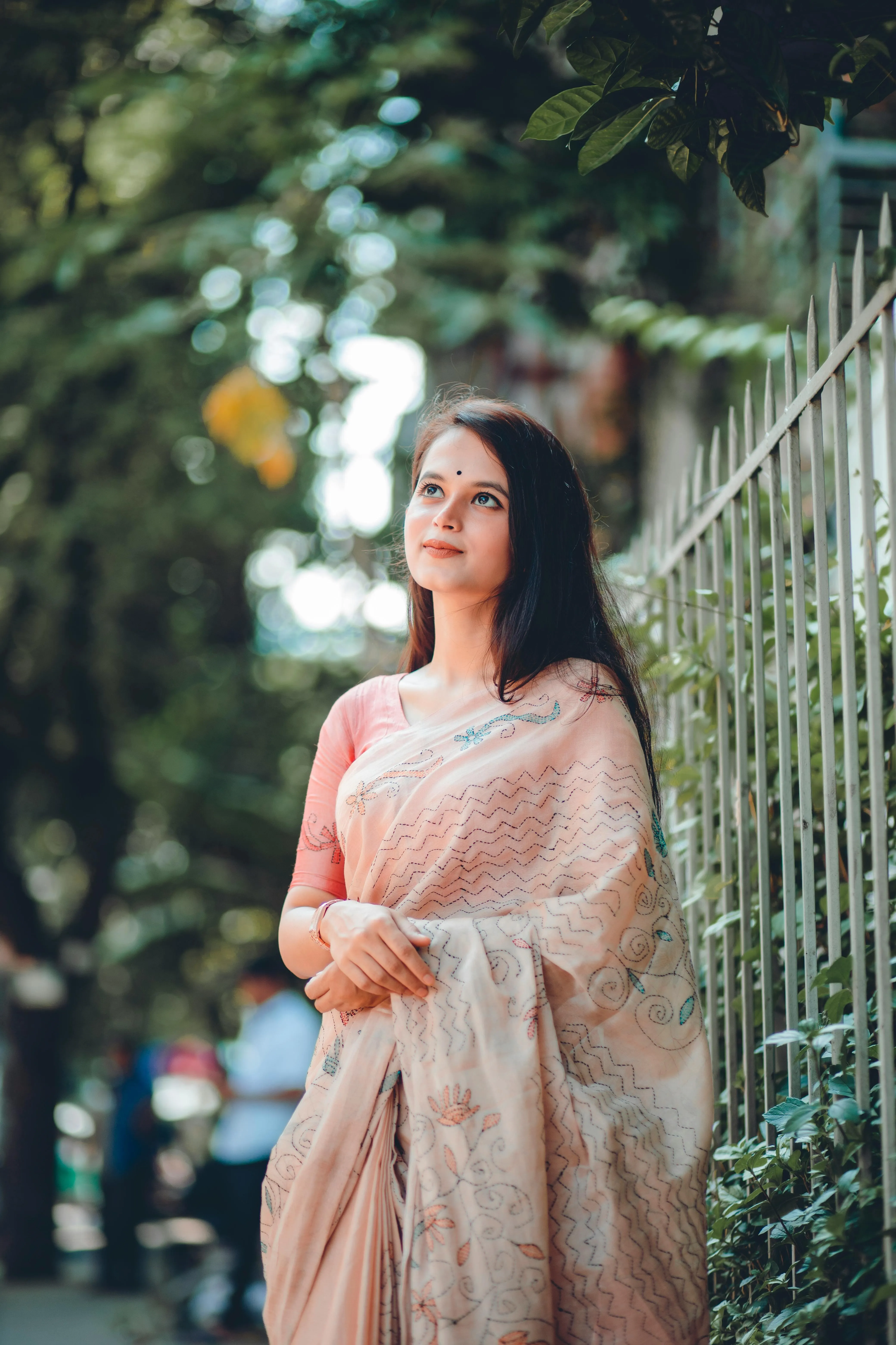 Young Woman in Cream Saree Standing Outdoors Gracefully