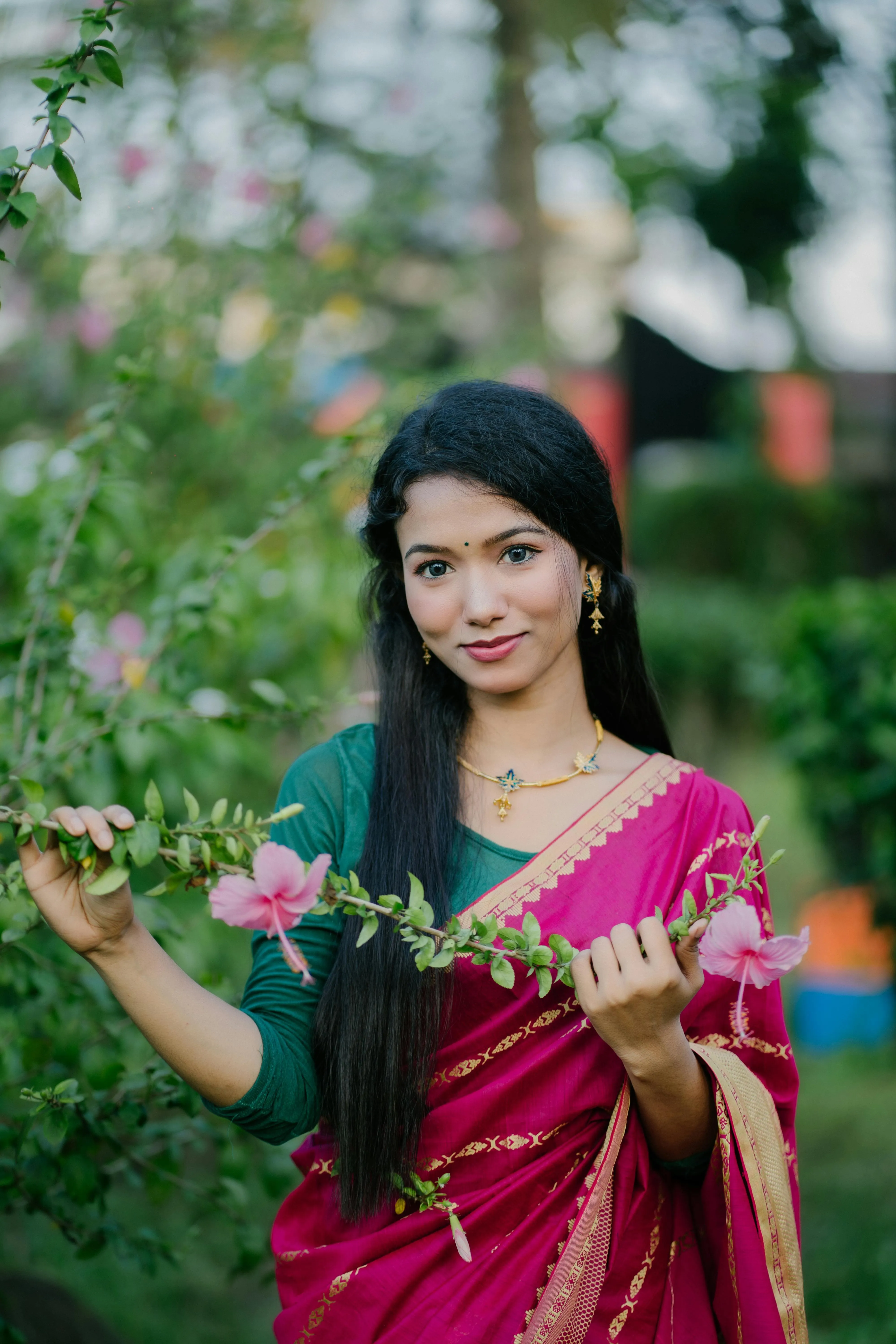 Young Woman in Green Saree Smiling in Nature Outdoors Image