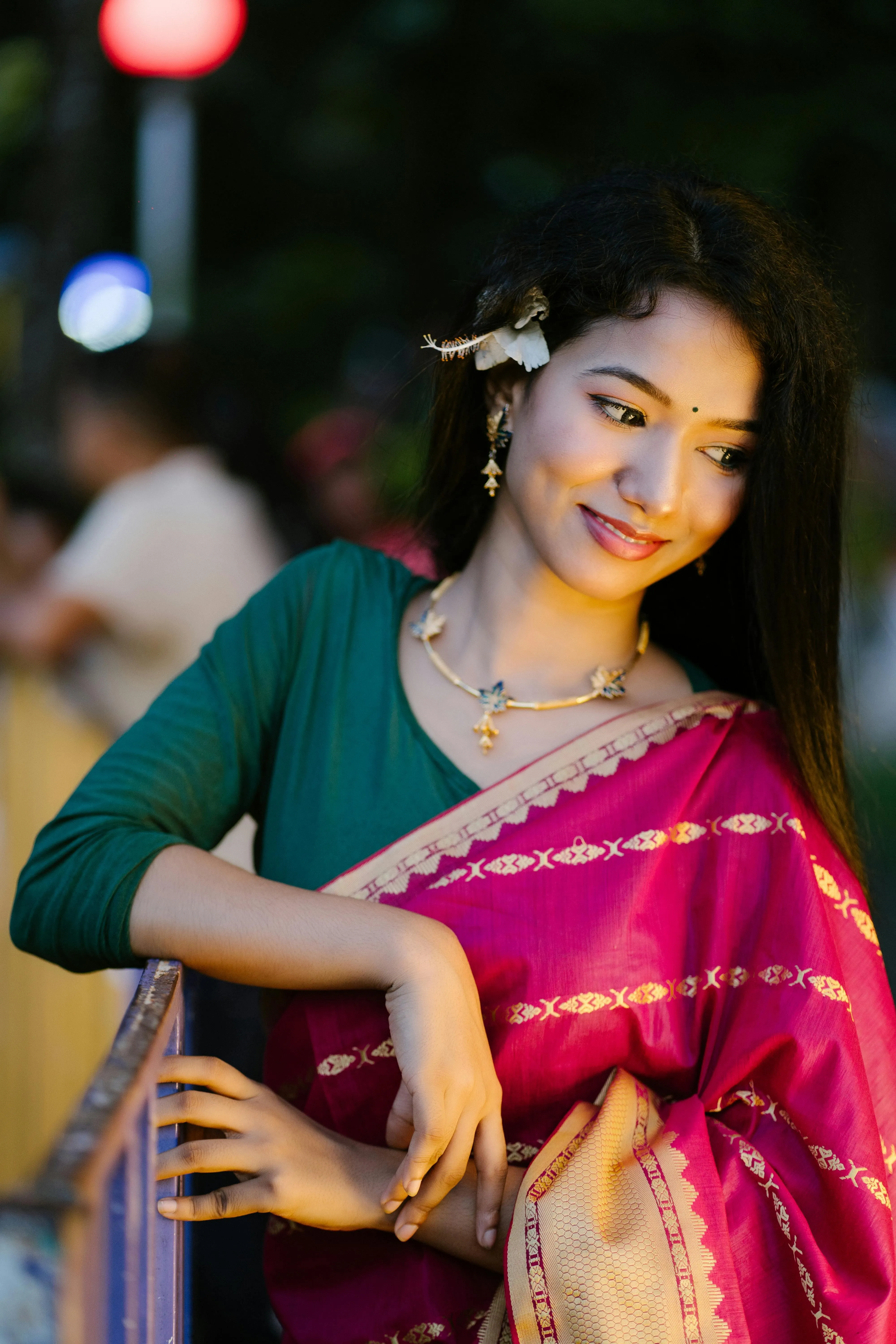 Young Woman in Green Saree Smiling While Holding Pallu Image