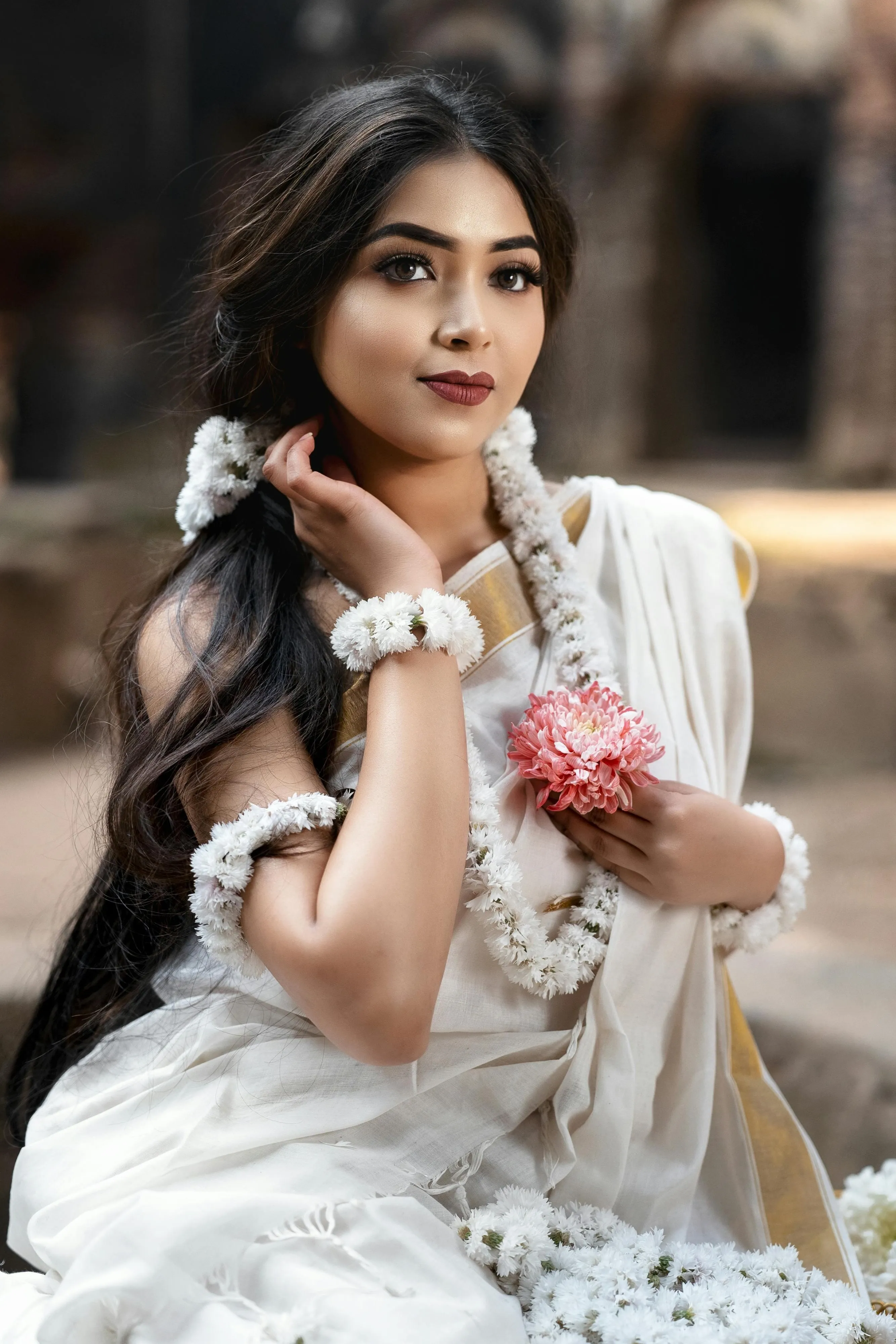 Young Woman in White Saree Posing Outdoors with Charm Image