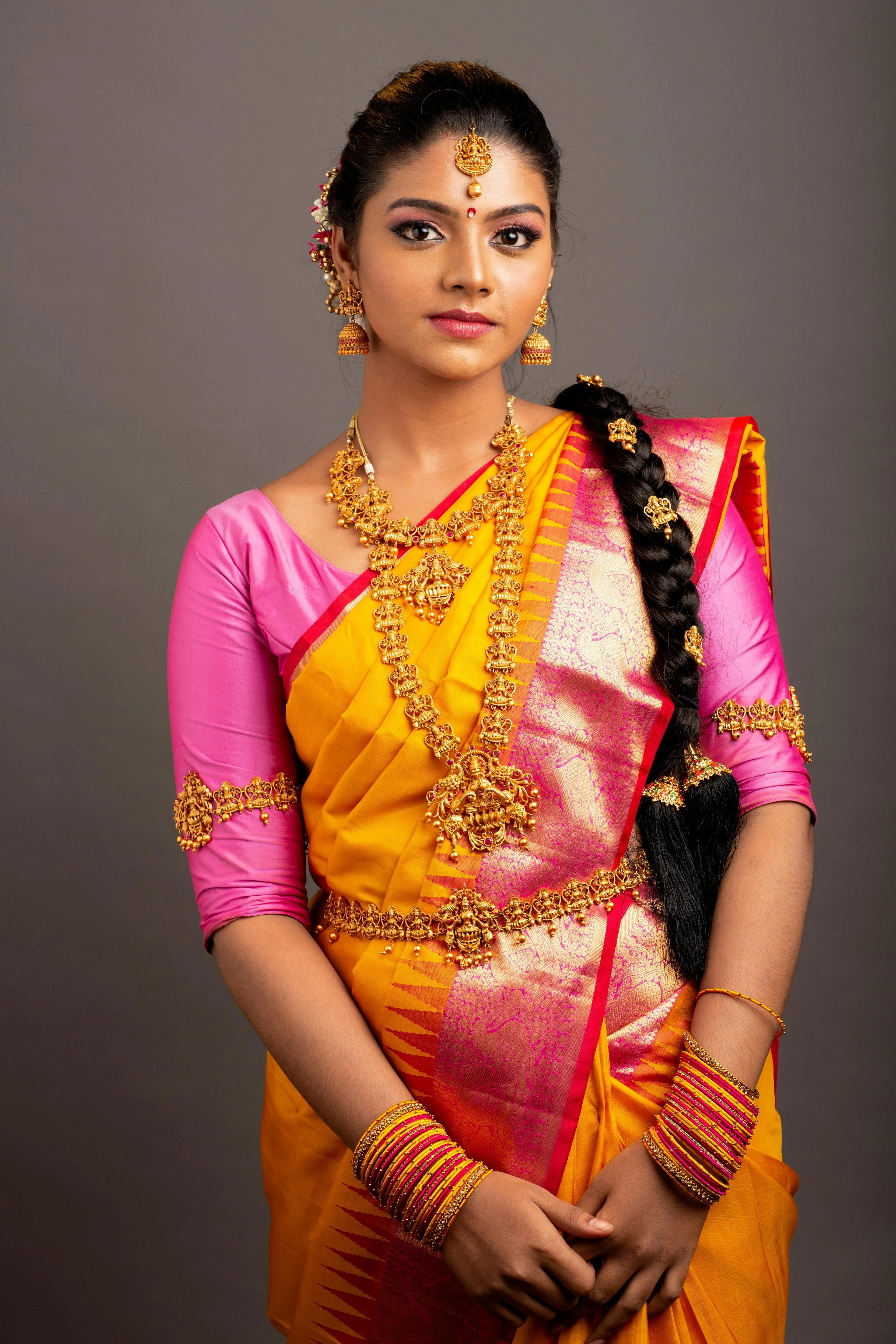 Young Woman in Yellow Silk Saree Posing with Elegance Image