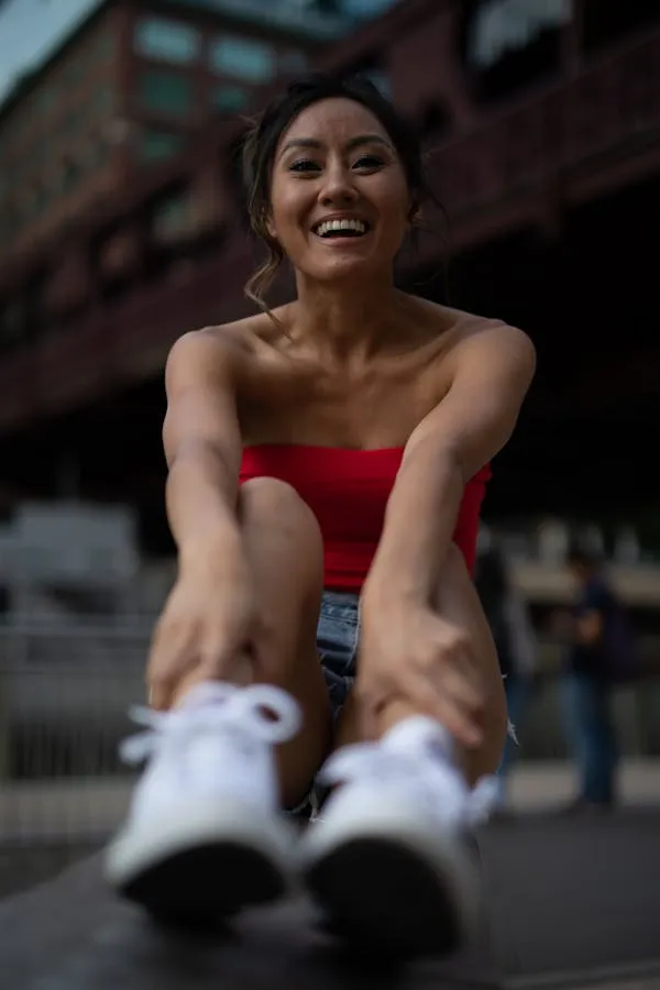 Young Woman Sitting on the Ground in a Sporty Outfit Outdoor