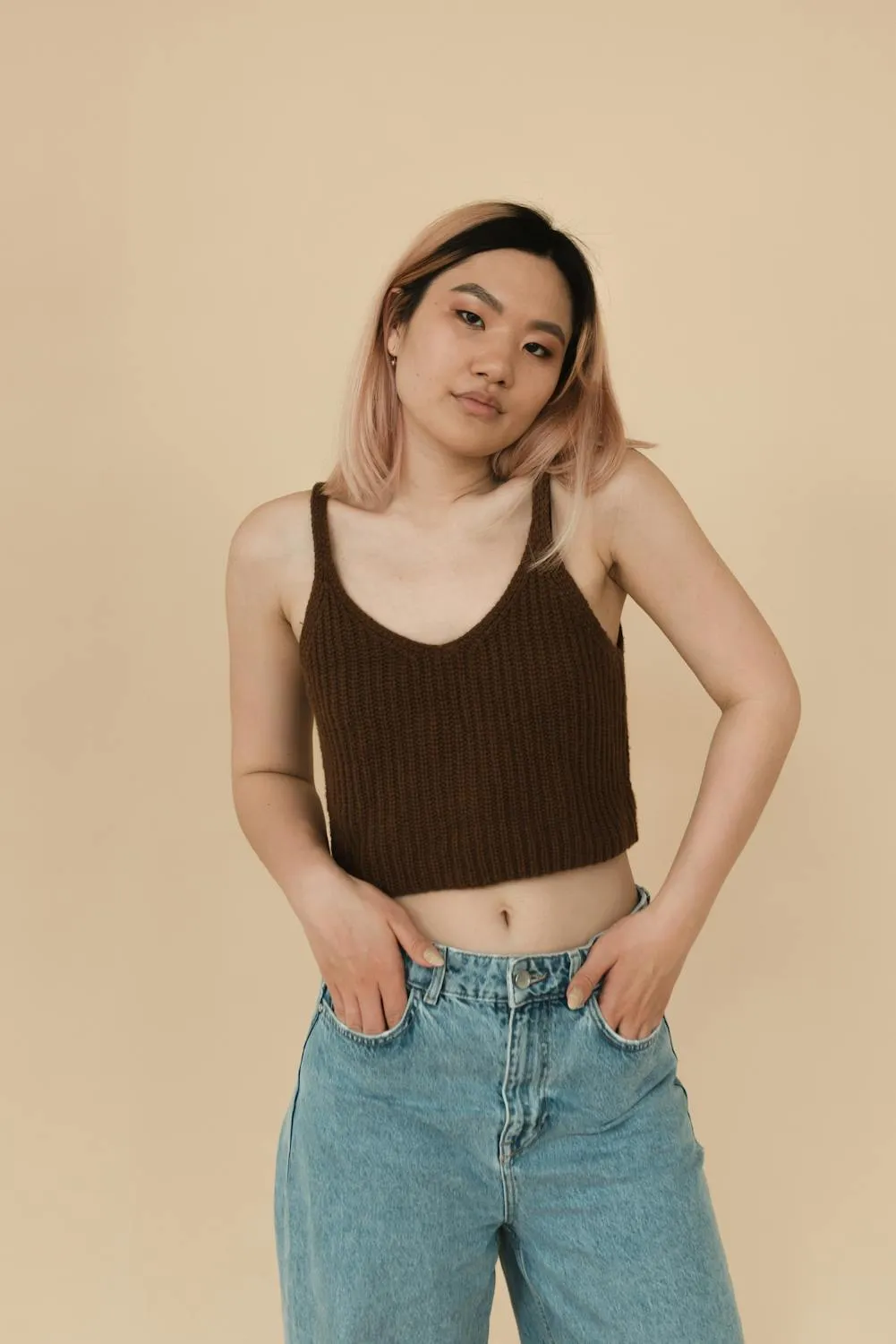 Young Woman Smiling with Her Hands in Her Pockets Wallpaper