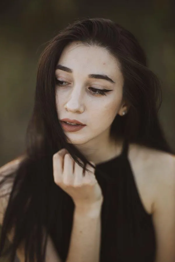 Young Woman with Soft Makeup Looking Down Hd Free Wallpaper