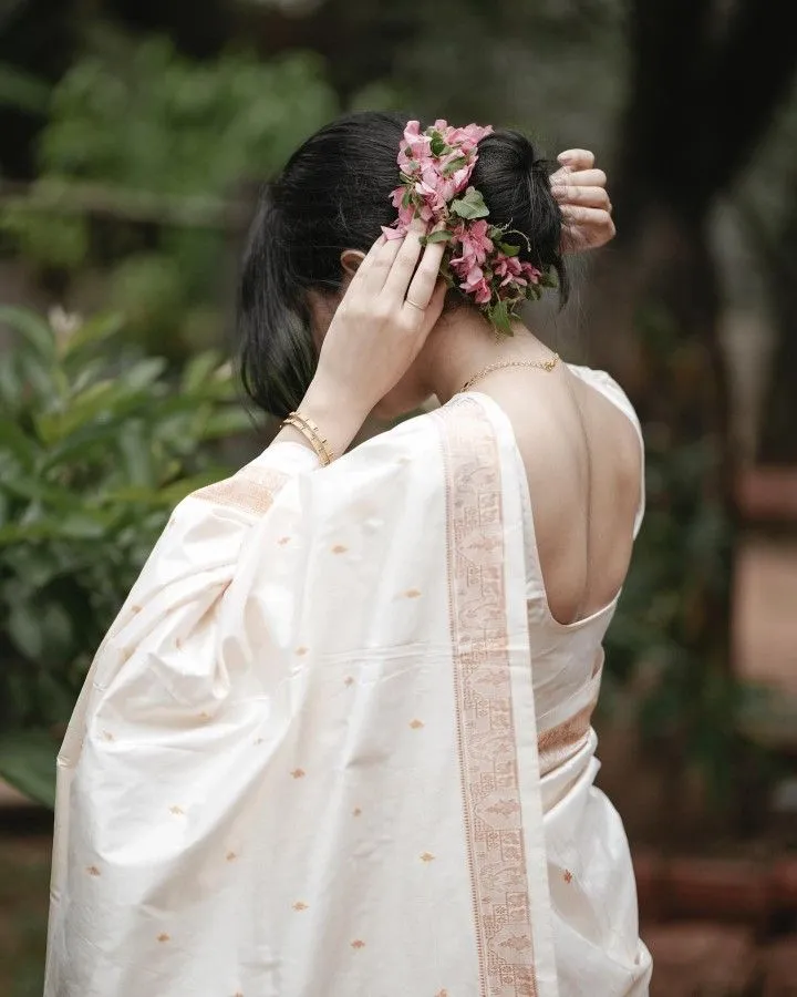 Young woman wearing a white dress with hand on her hair