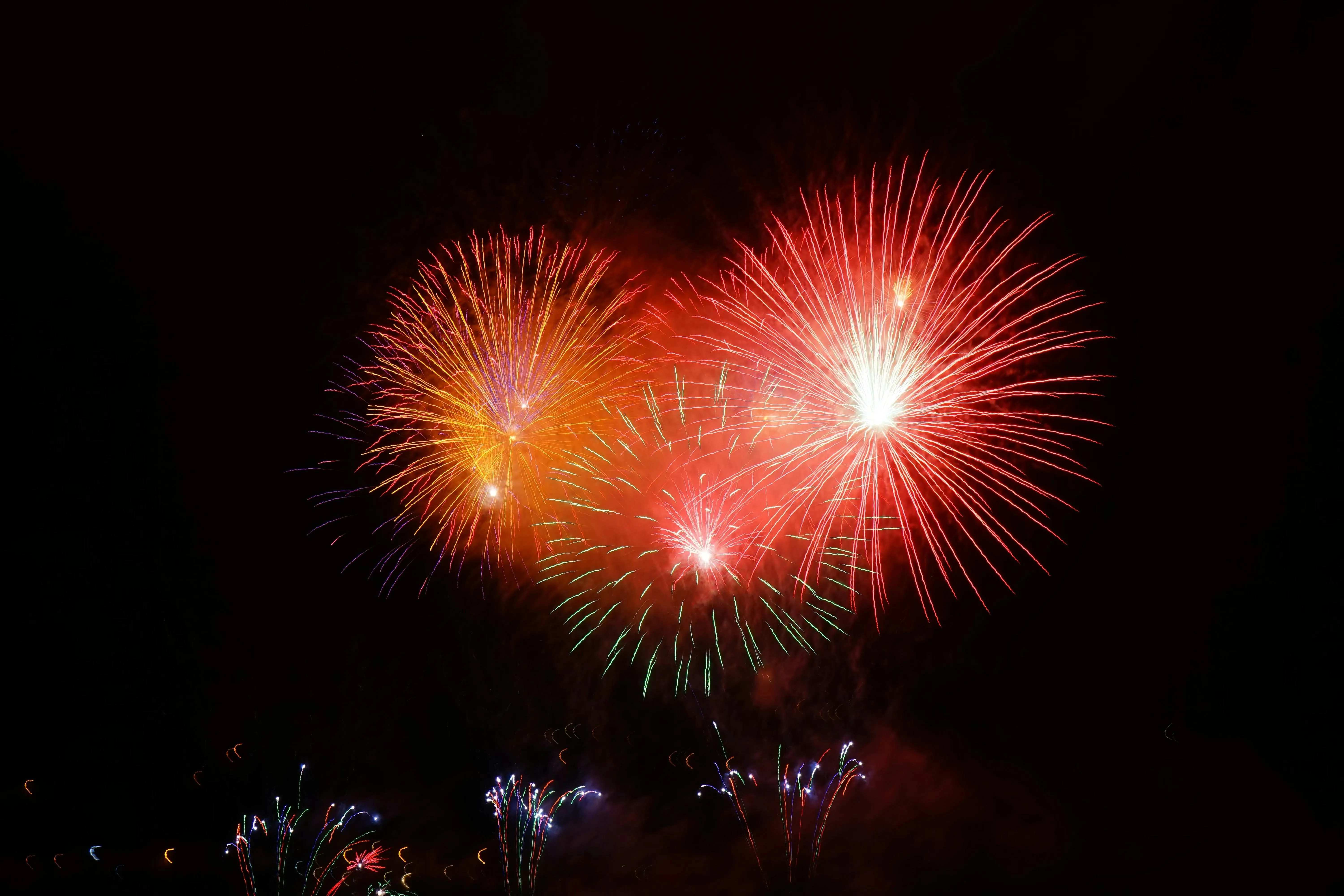 A burst of colorful fireworks lighting up the sky HD image