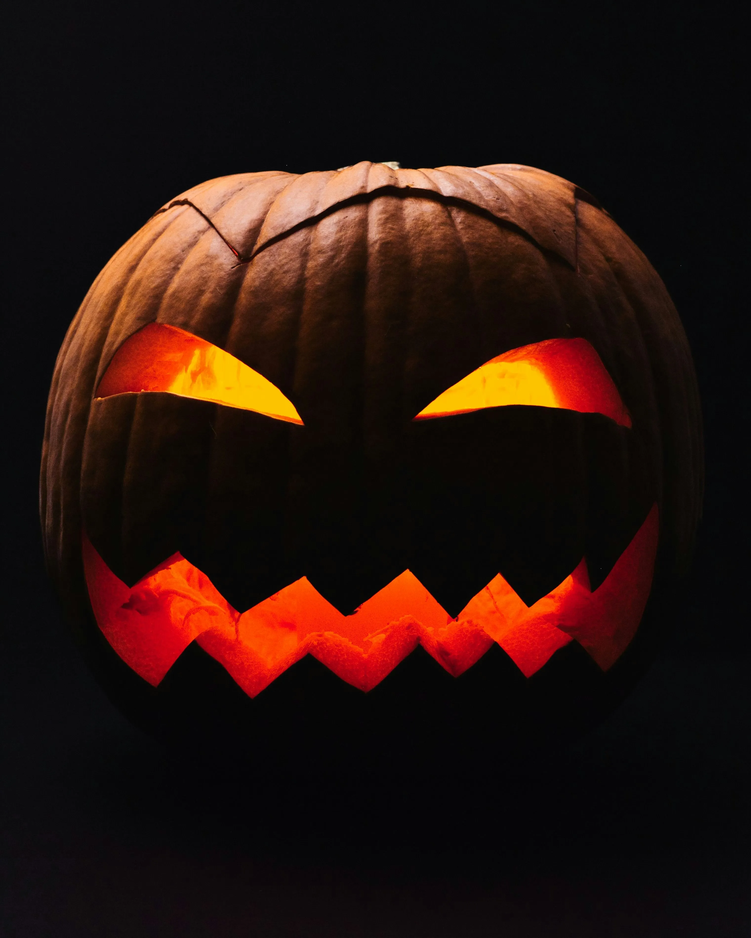 Angry Jack O Lantern Face with Sharp Teeth in Dark Image