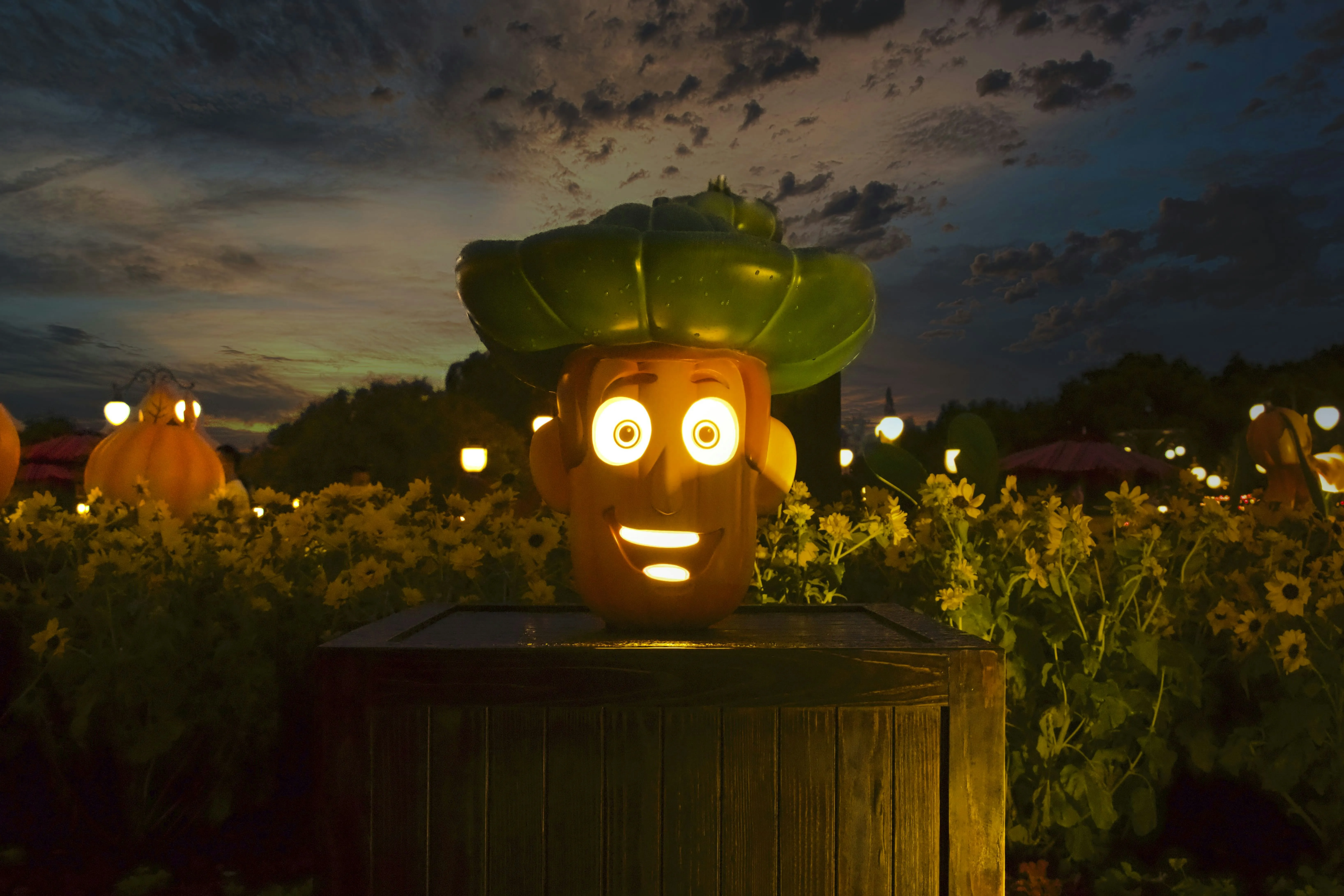 Animated Green Glowing Pumpkin Head at Sunset Wallpaper