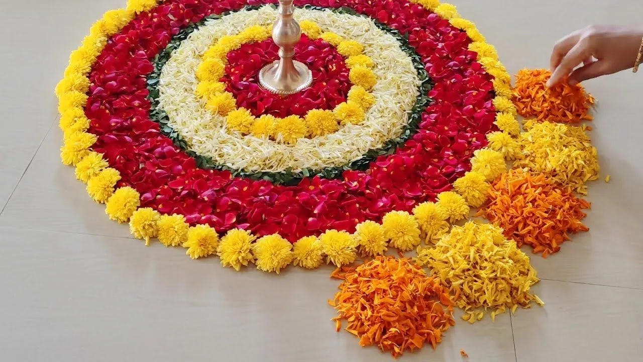 Athapookolam with marigold flowers and rose petas with lamp