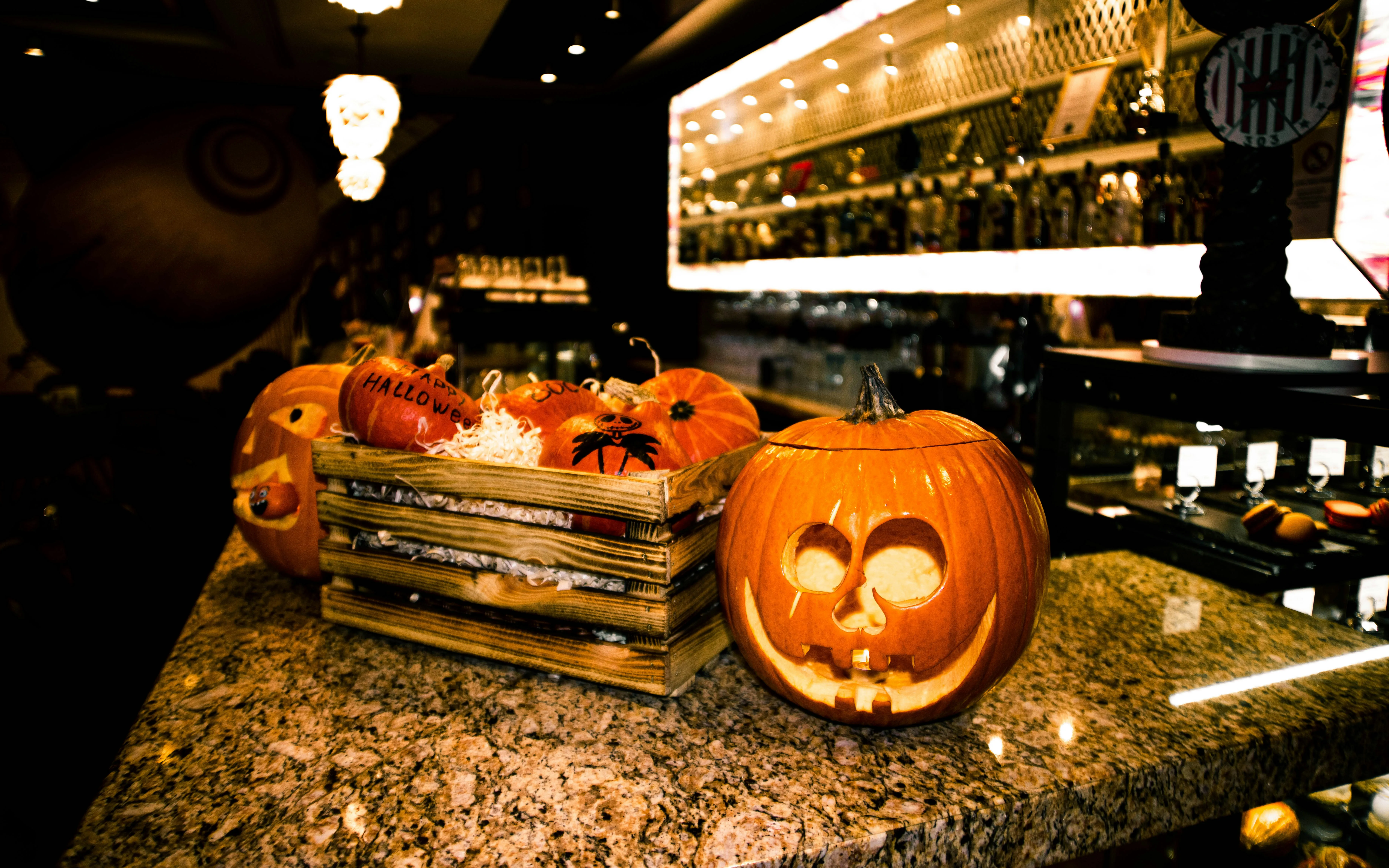 Bar Counter Decorated with Glowing Halloween Pumpkins Image