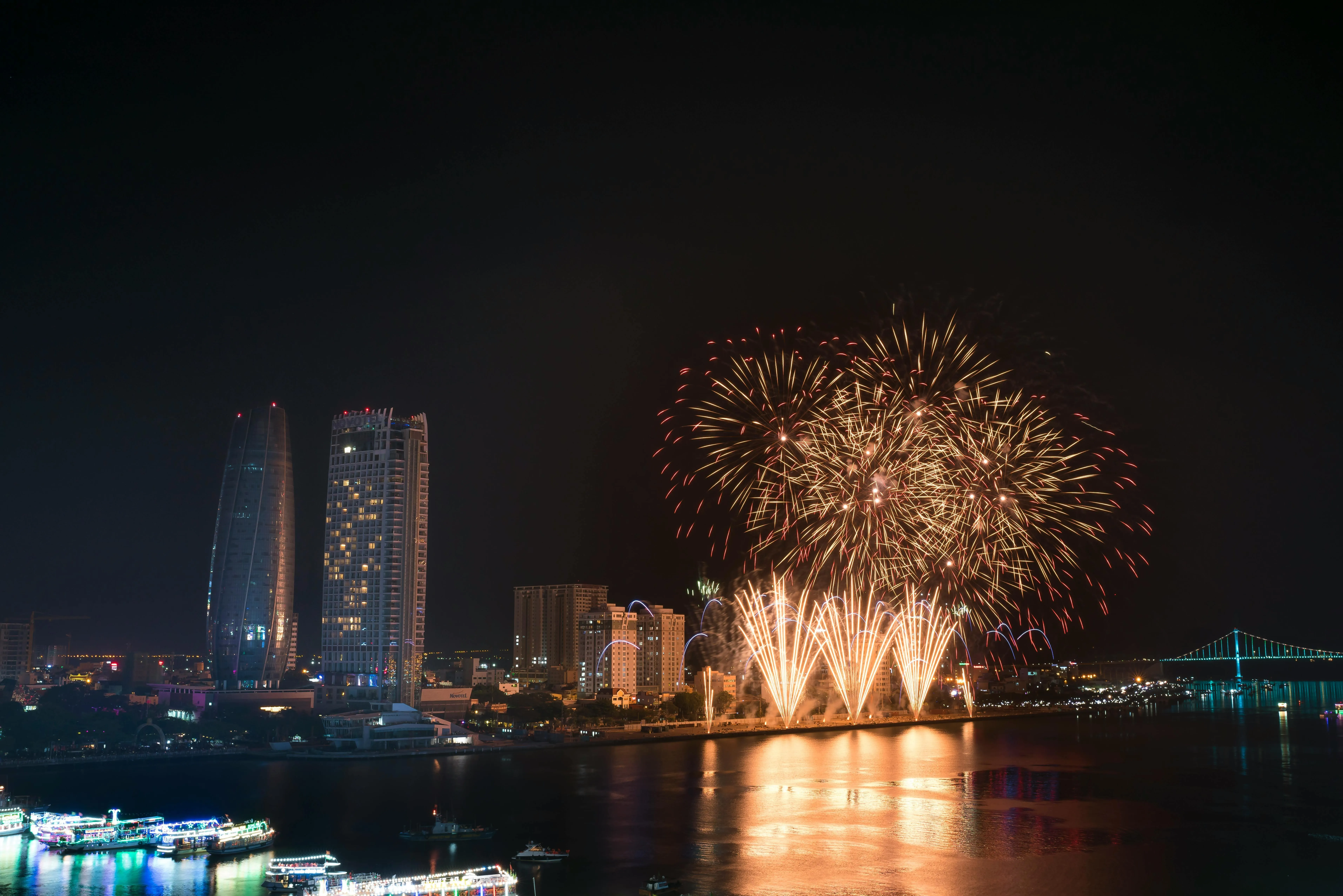 Beautiful fireworks lighting up the cityscape along waterfront