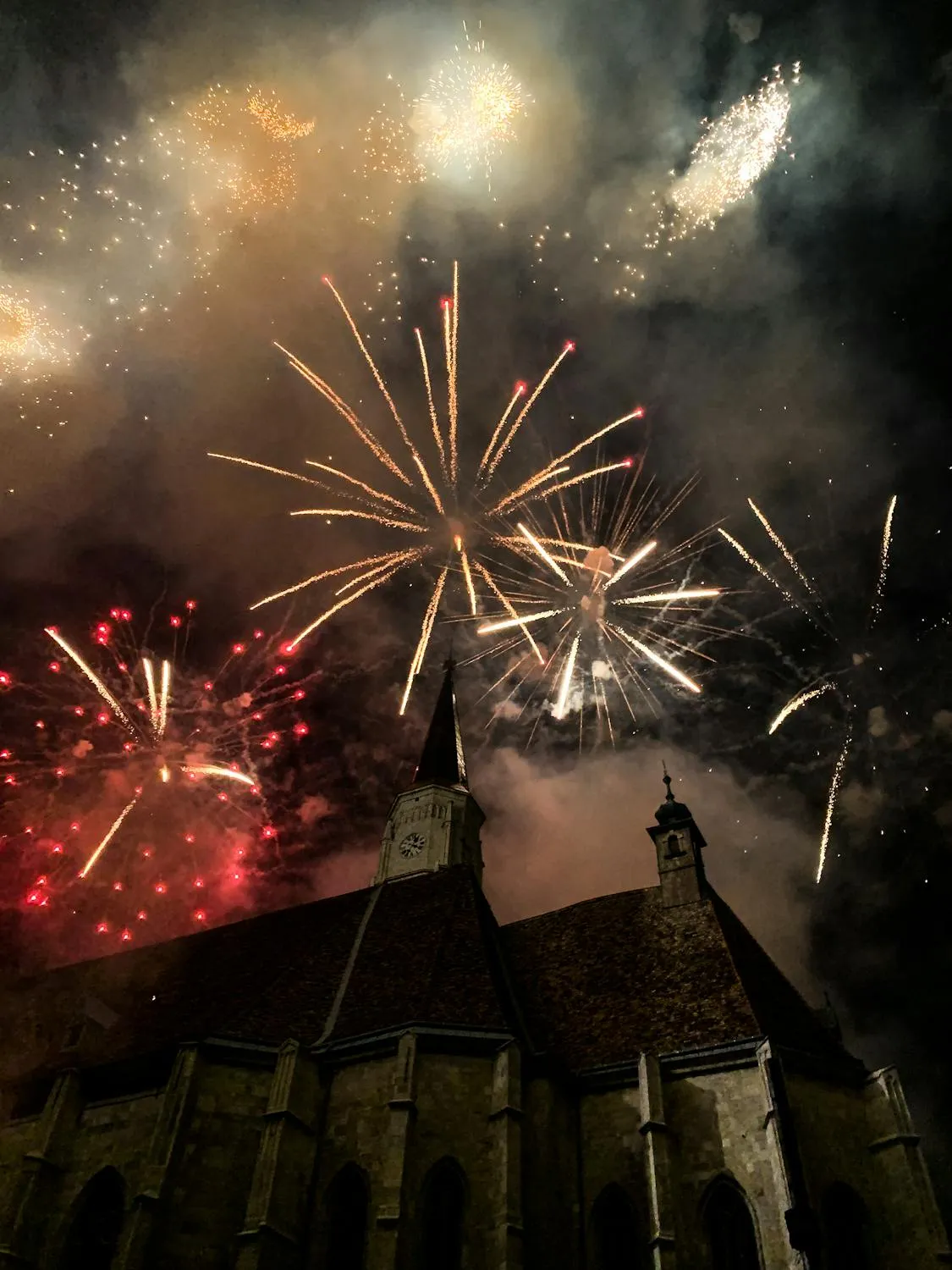 Beautiful fireworks lighting up the night over buildings