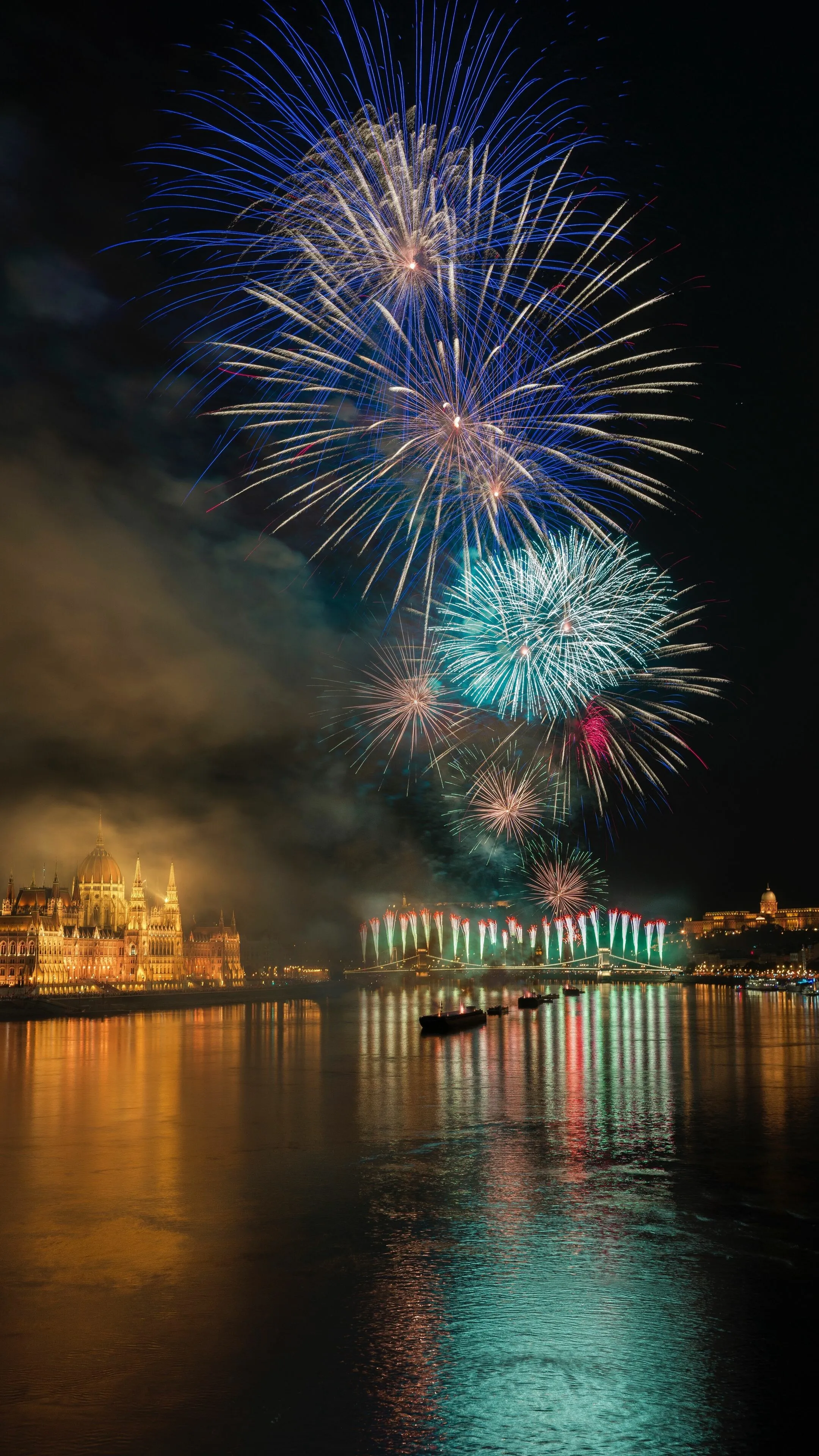Beautiful fireworks reflecting on the water surface at night
