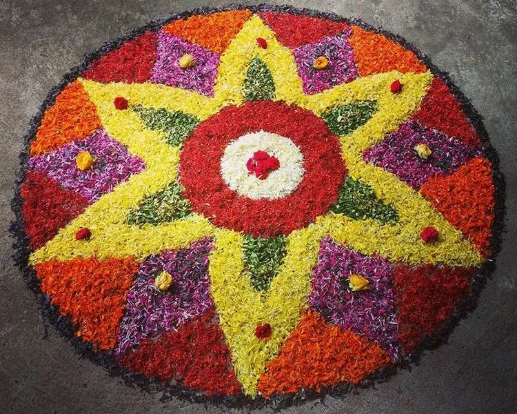 Beautiful Onam kolam design with colourful petals HD image