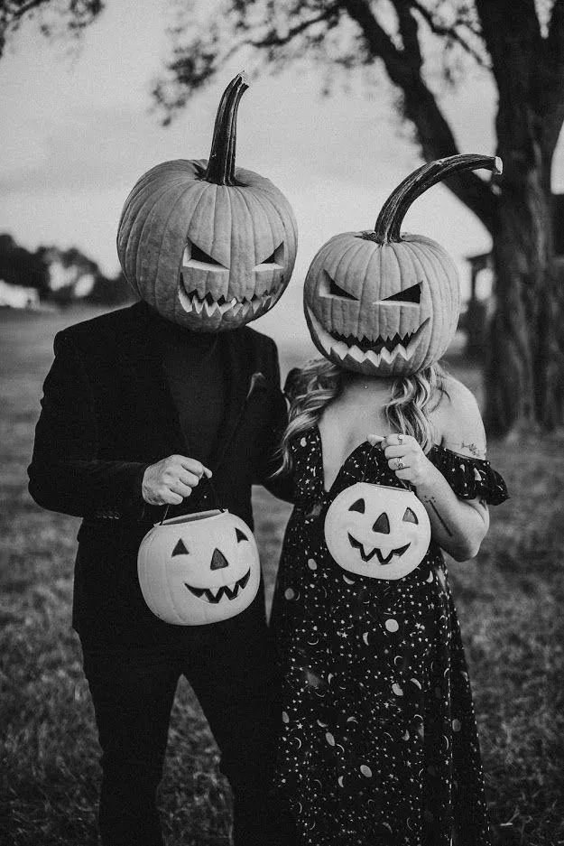 Black and White Image of Two People Wearing Pumpkin Head Masks