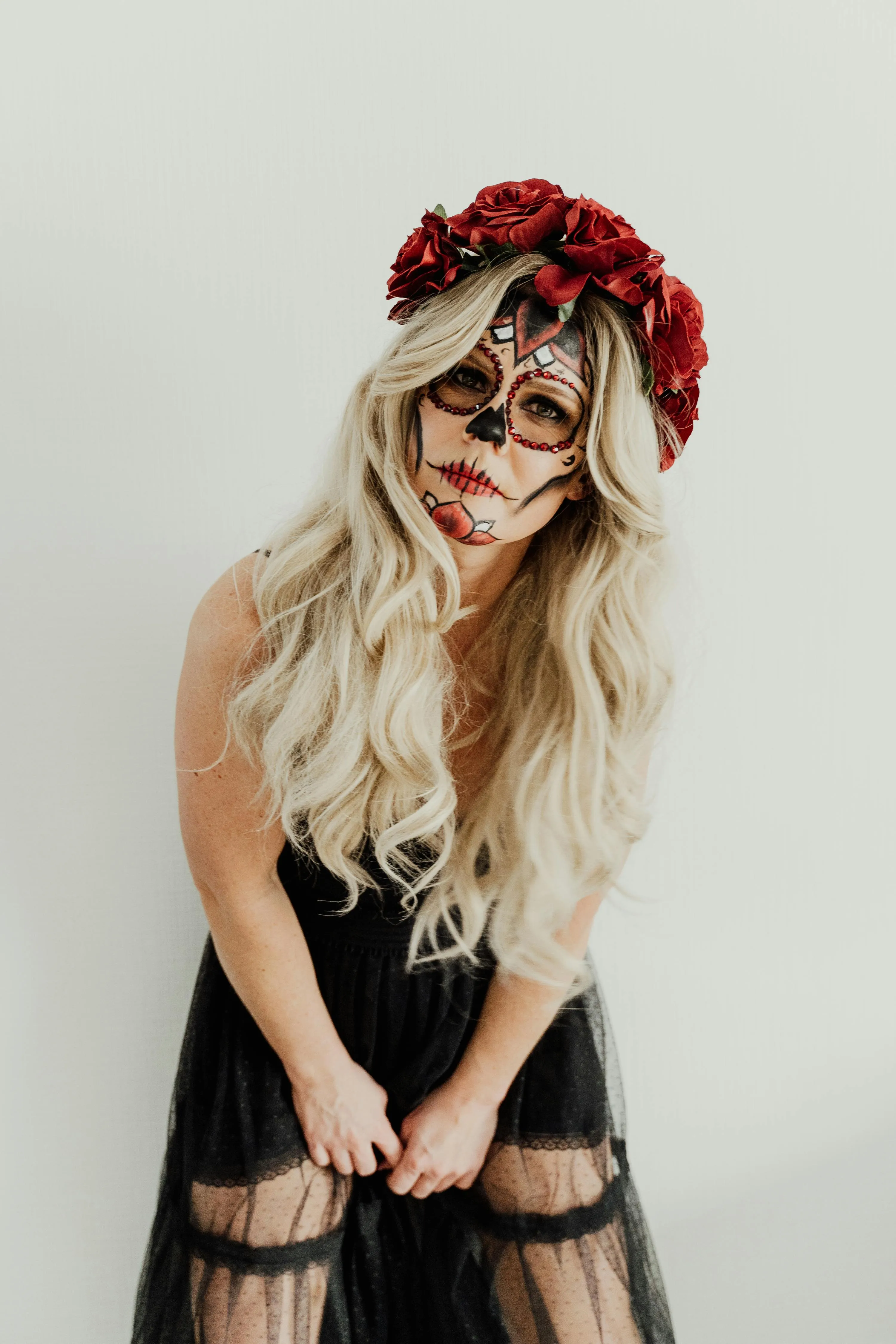 Blonde Woman Smiling Wearing Skull Makeup and Flowers