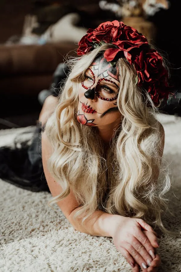 Blonde Woman with Red Flower Crown Lying Down in Soft Light