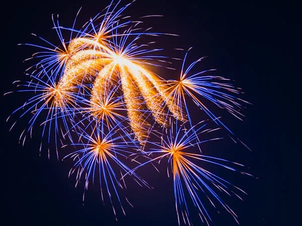 Blue gld Fireworks bursting in different directions at once