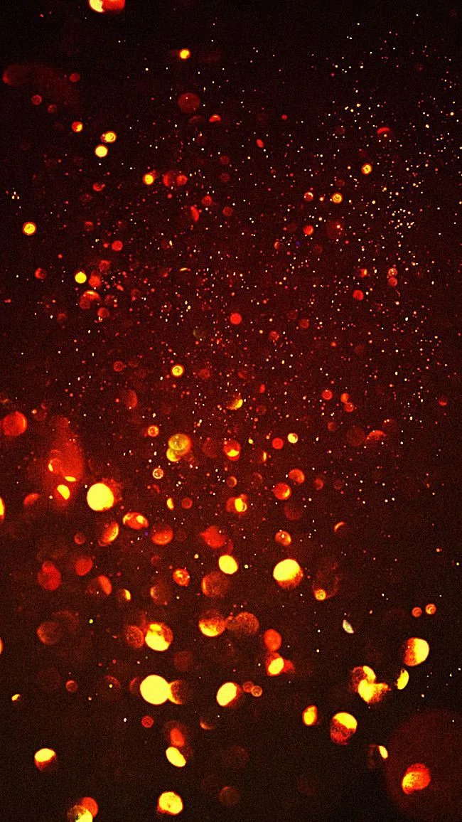 Blurry red orange fireworks with glowing particles in air