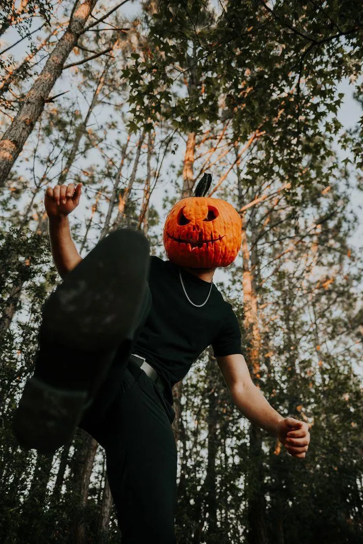 Boy in Pumpkin Head Costume posing against forest image
