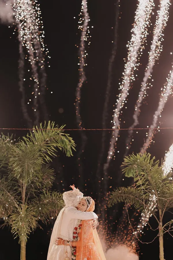 Bride and Groom Embrace with Fireworks in the Background