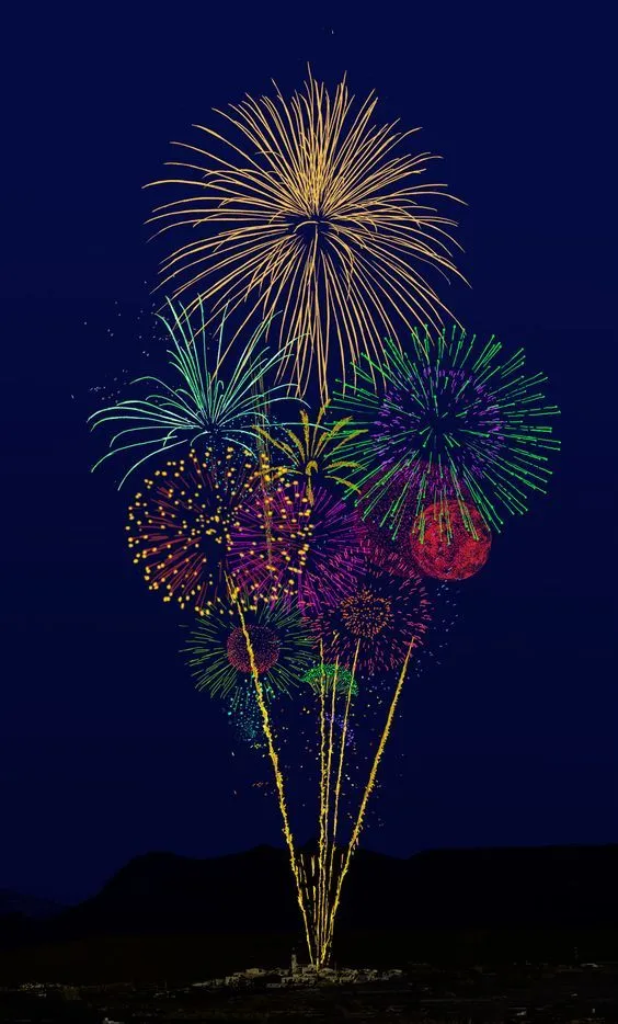 Bright and Colorful Fireworks in a Dark Sky Wallpaper