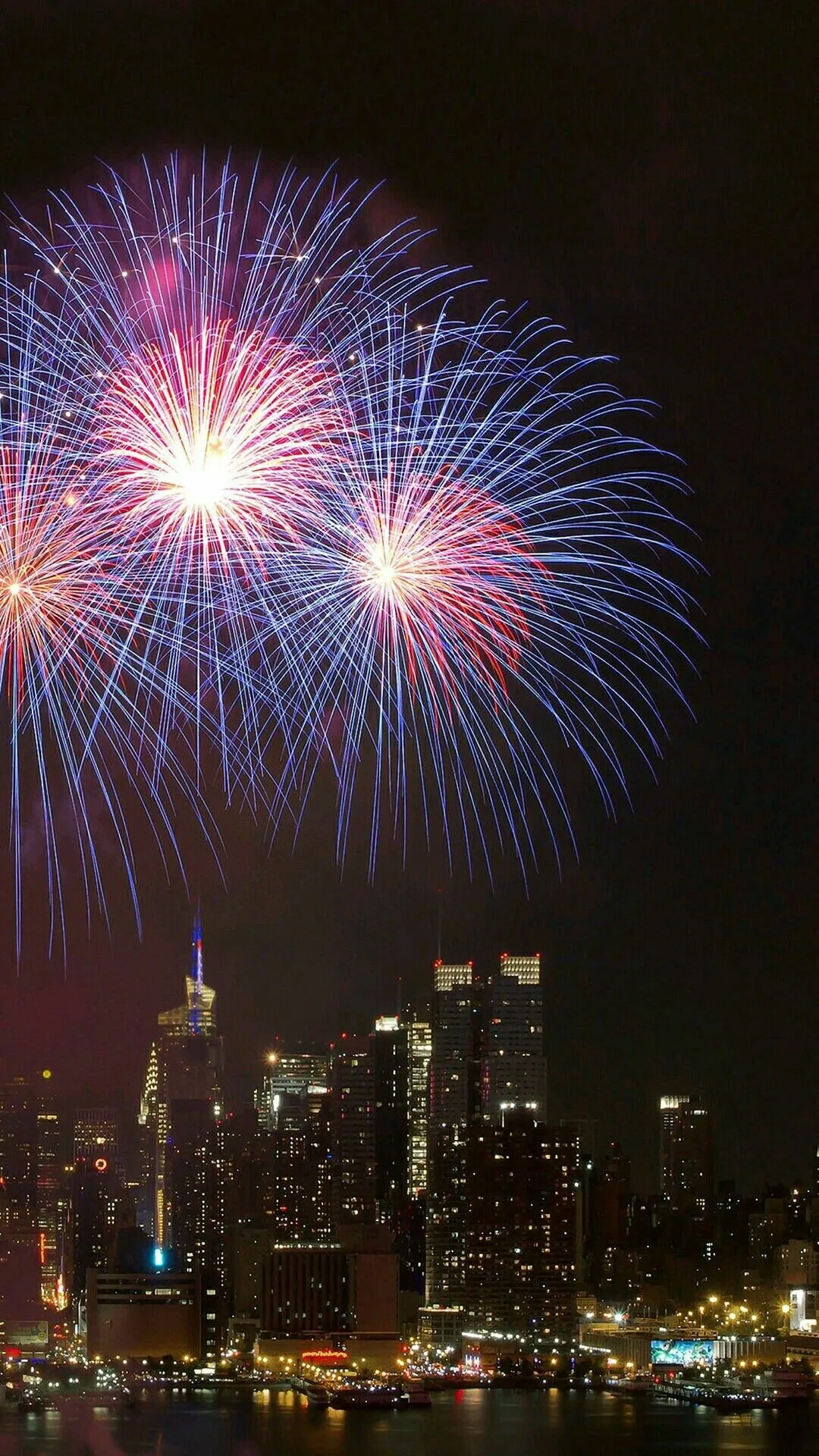 Bright Fireworks Lighting up the Sky above the City Skyline