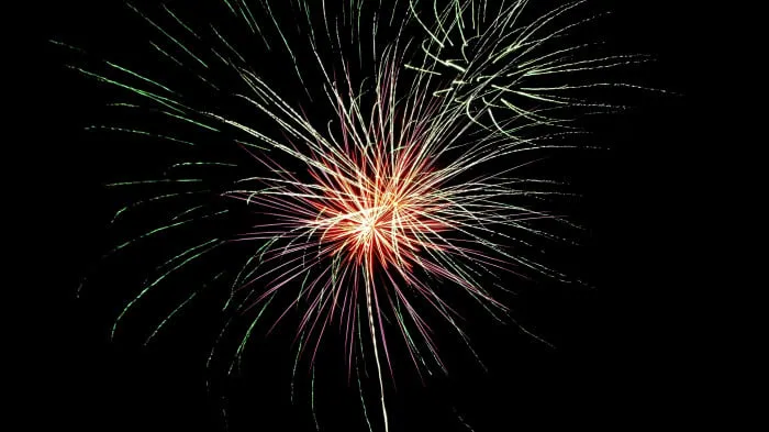 Bright Red and Green Firework Explosion in the Sky