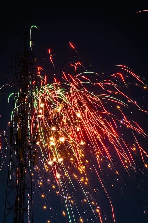 Bright red and orange fireworks illuminating the sky