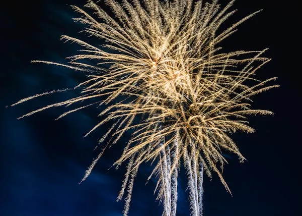 Bright Yellow and Green Firework Explosions Wallpaper