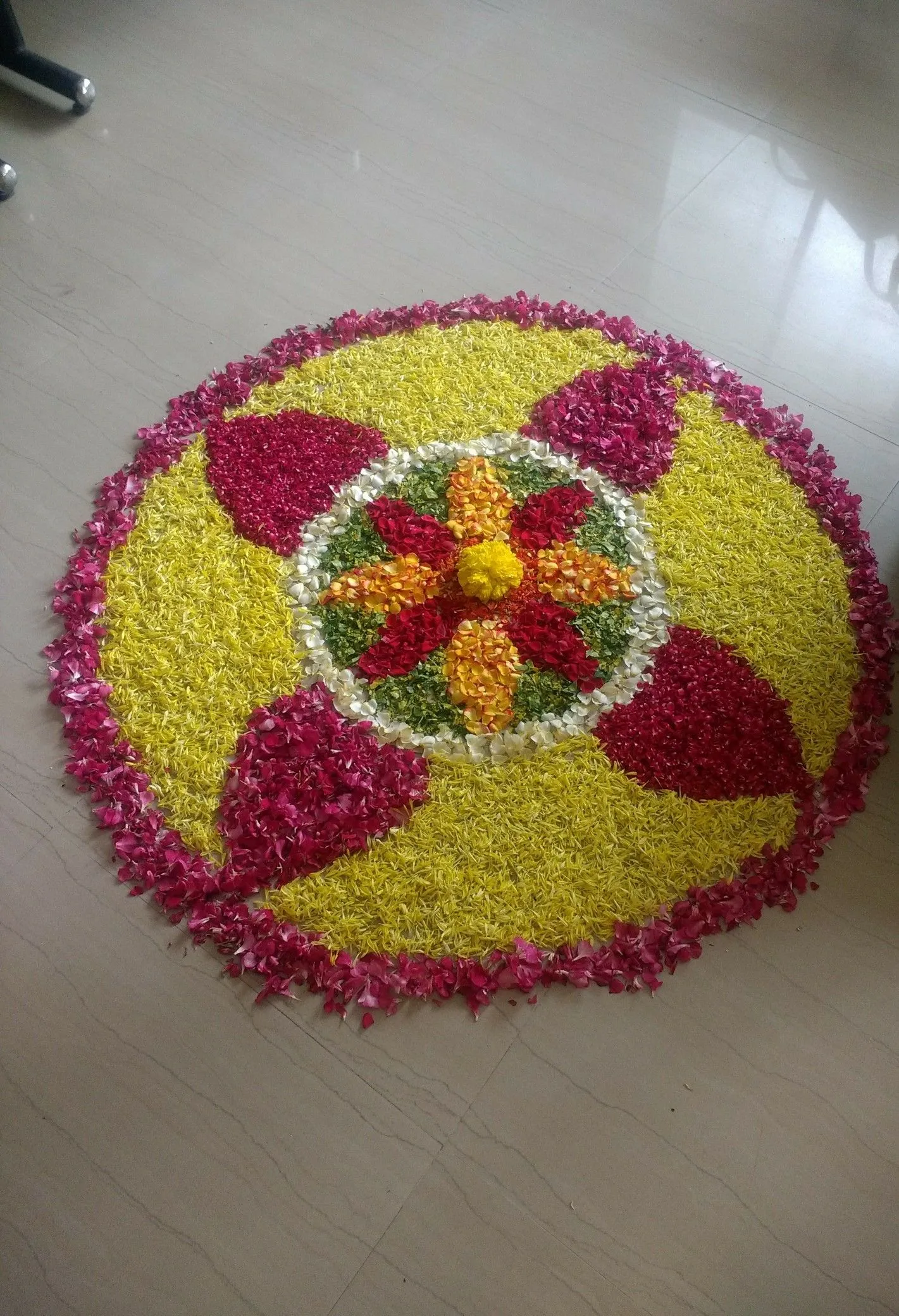 Bright yellow pookolam with pink petal border HD image
