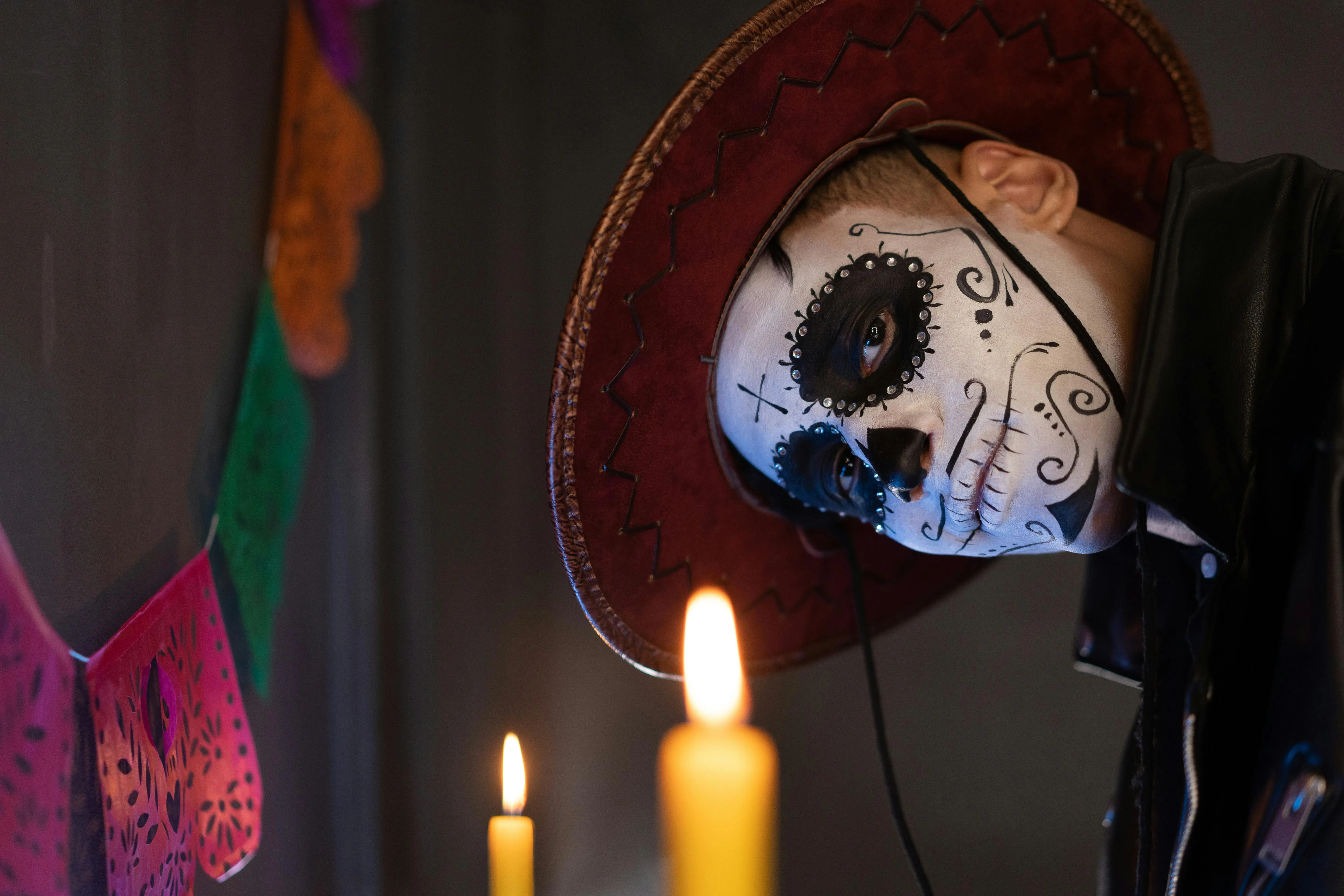 Candlelit Man in Skull Makeup and Red Hat free HD image