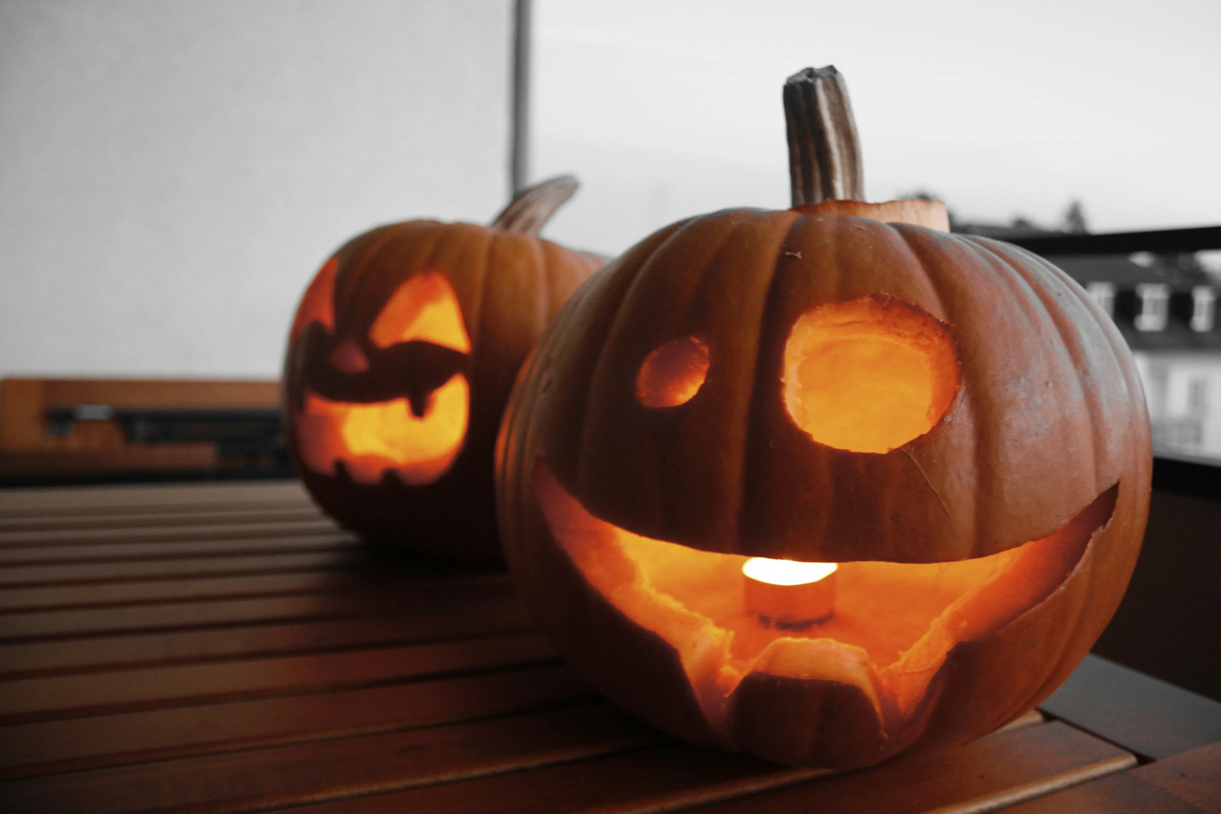 Carved Pumpkins on Wooden Table in Cozy Kitchen Wallpaper