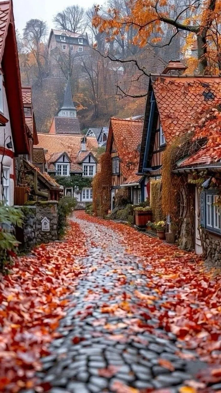 Charming Cobblestone Path with Autumn Leaves and Halloween Decor