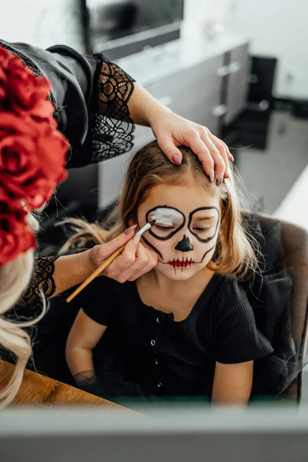 Child Getting Artistic Halloween Face Paint Application