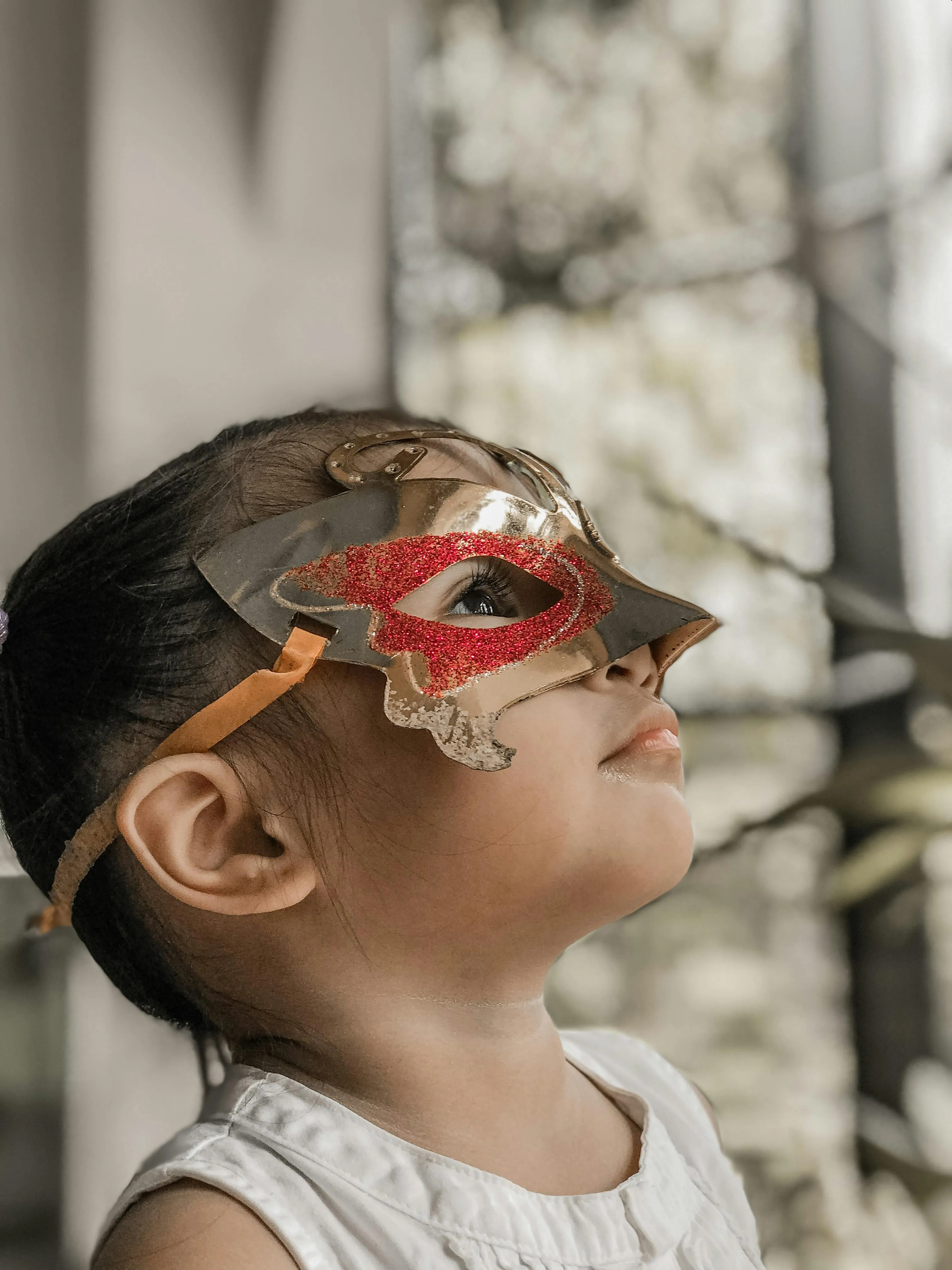 Child Wearing Red Mask at Halloween Festival Wallpaper