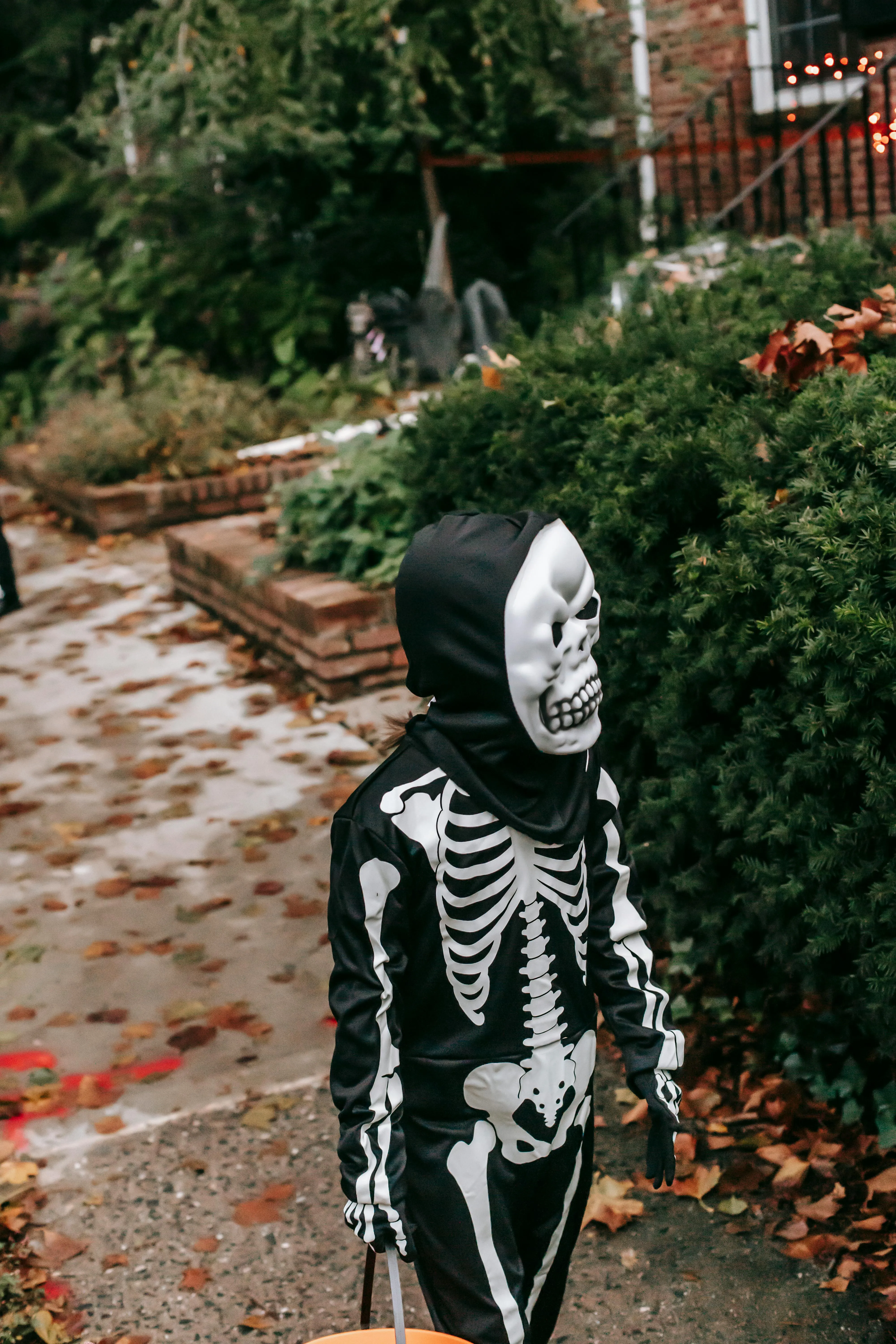 Child Wearing Skeleton Costume Outdoors at Halloween