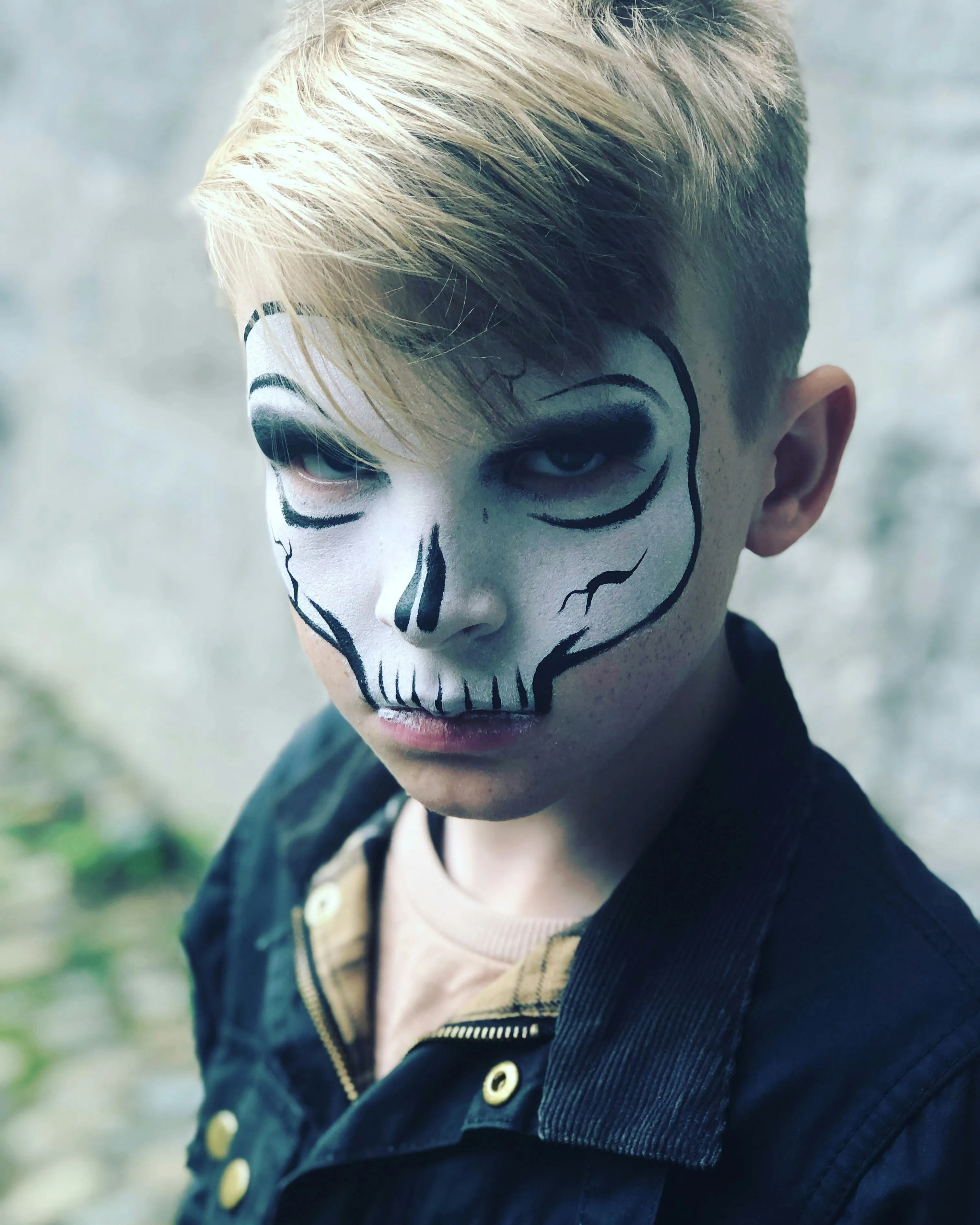 Child with Skeleton Face Paint for Halloween Festival