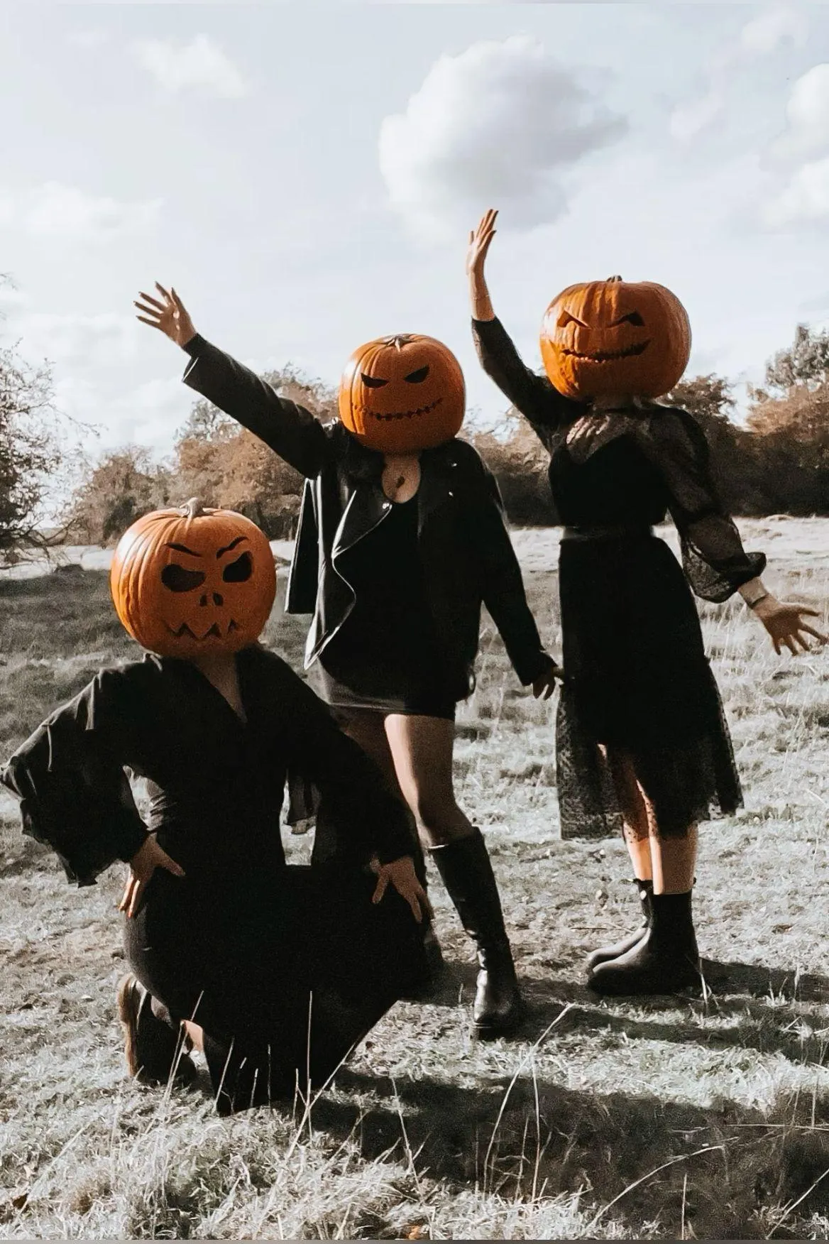 Children in Pumpkin Masks Playing Outside in Autumn