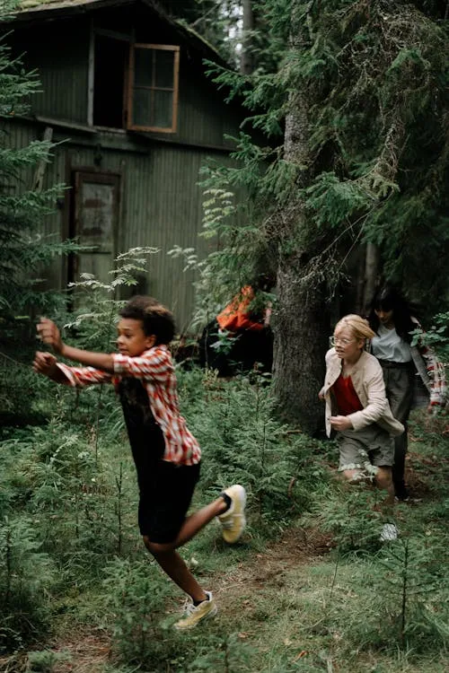 Children Playing in Halloween Costumes Outside Wooden House