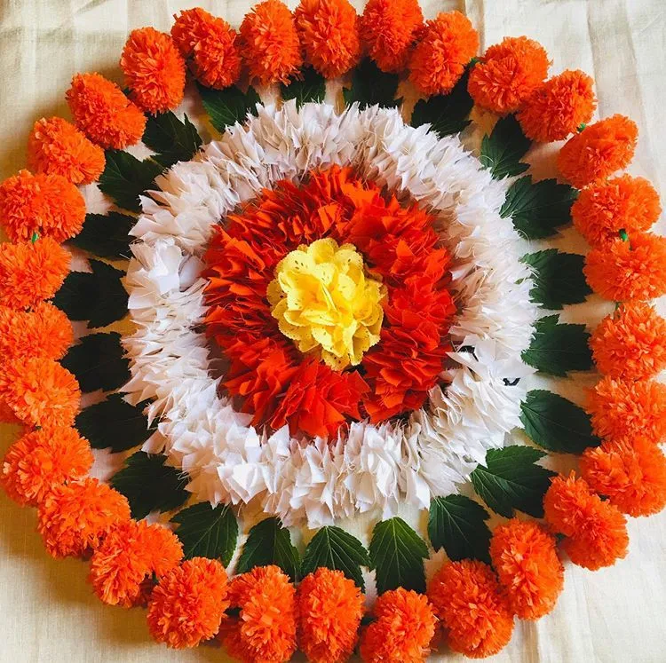 Circular design pookolam with marigolds and leaves images