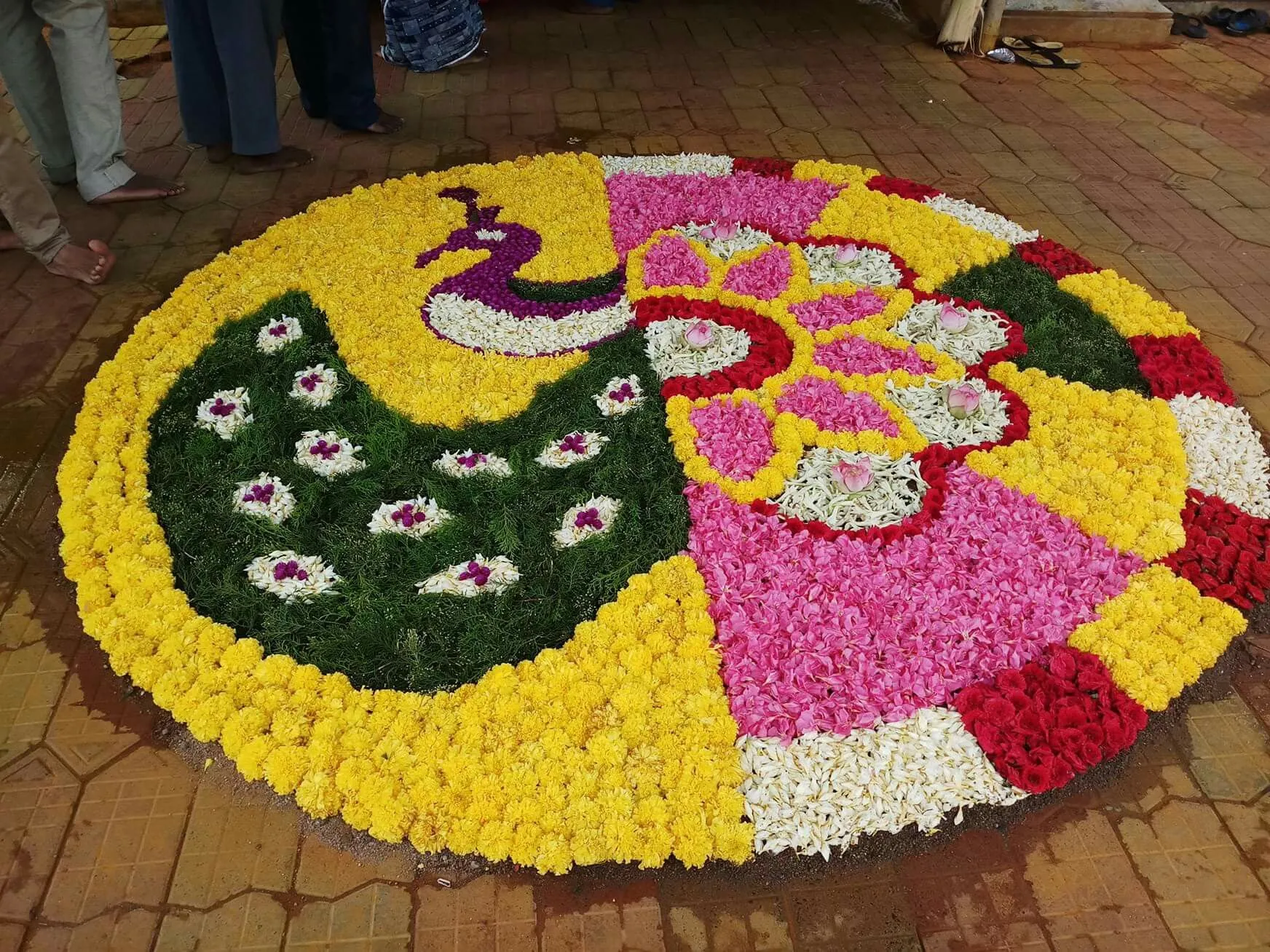 Circular kolam with peacock and floral design on each side