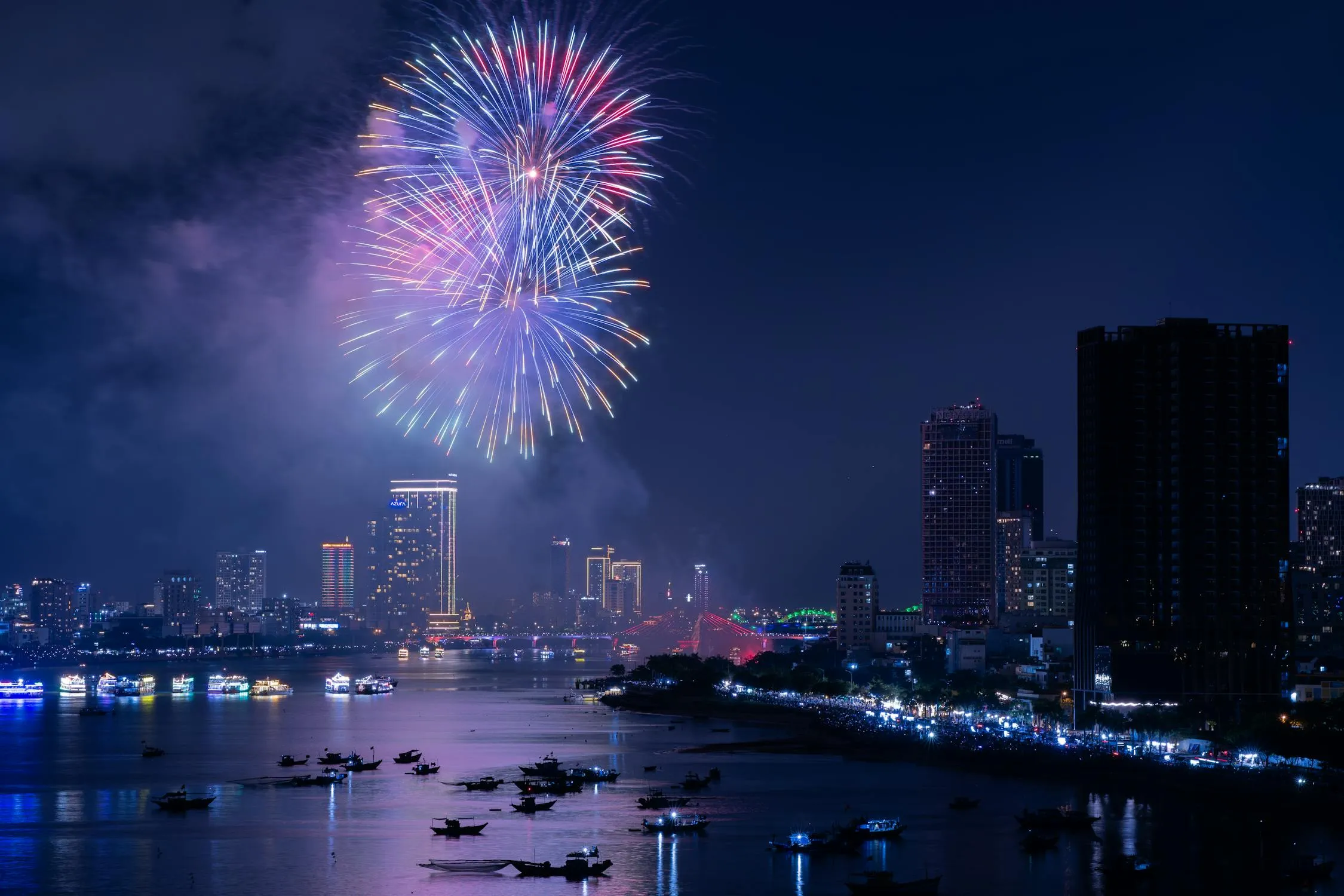 City skyline with vibrant fireworks exploding in the night sky